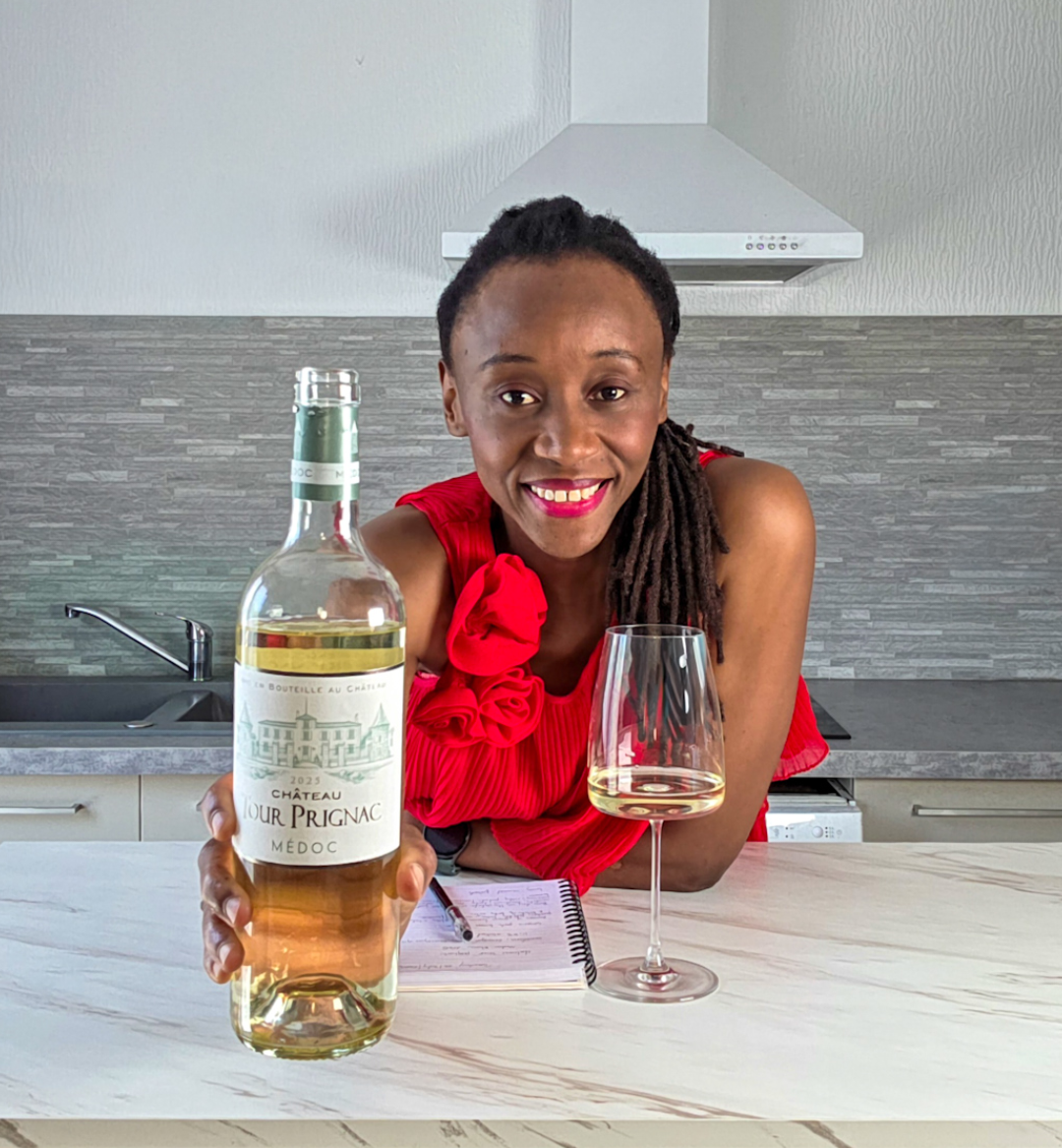 Mulongo Binti Simiyu, DipWSET wine consultant, tasting Château Tour de Prignac 2025 Médoc Blanc in her kitchen — a white wine from Bordeaux's Médoc region.