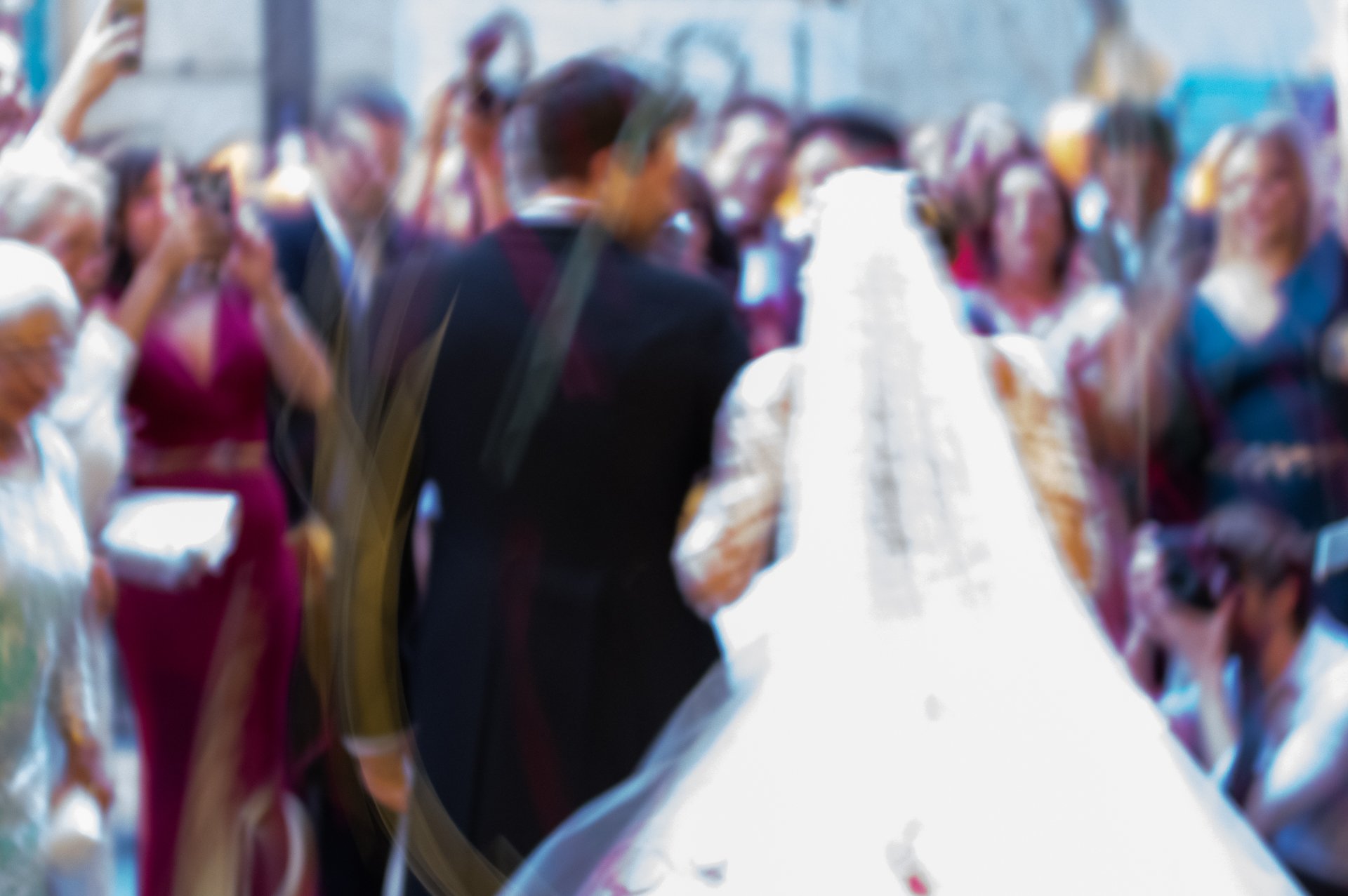 documentary photography of a bride and groom exit a church in Suffolk wedding after their ceremony