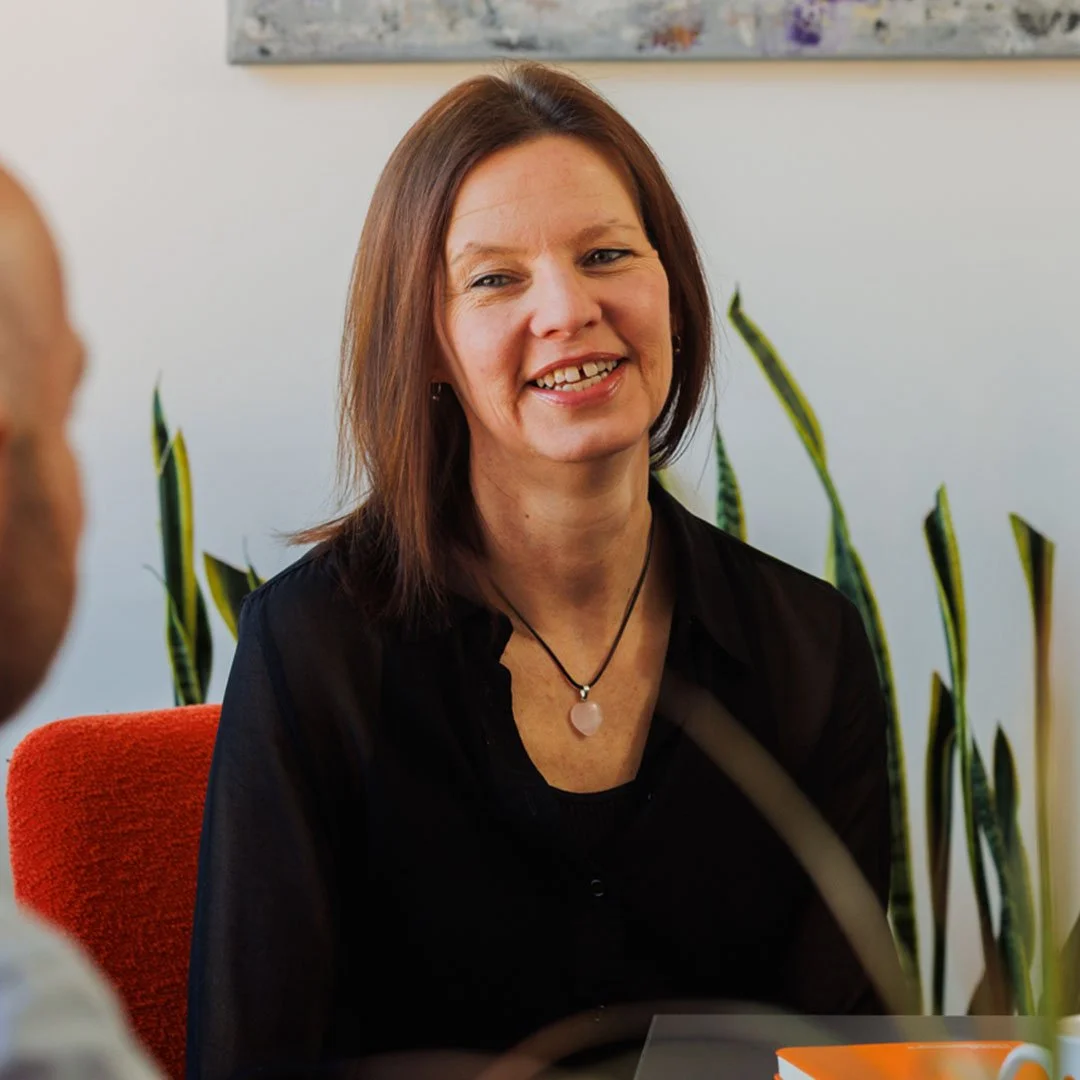 Sam smiling during a meeting at Edwards Insurance Brokers