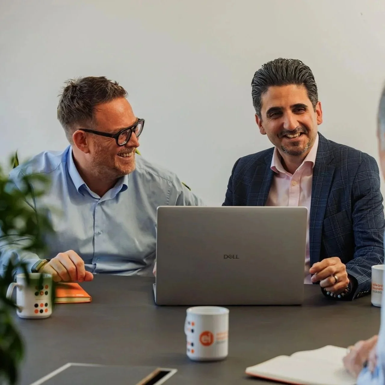Chris and Alan smiling during a meeting at Edwards Insurance Brokers