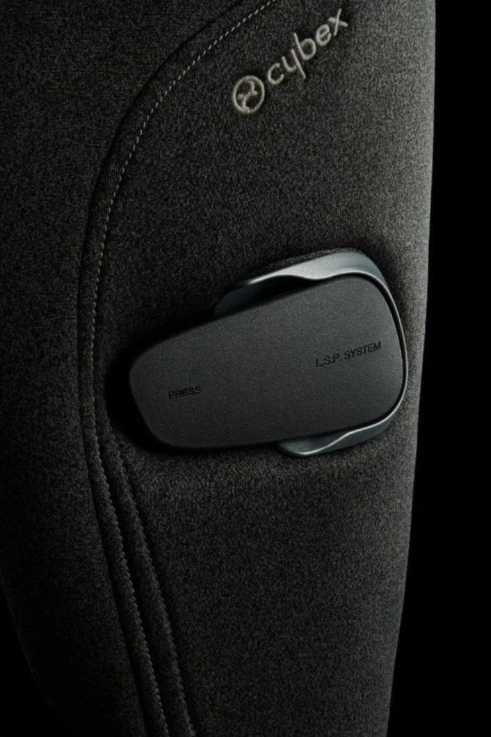 Close-up of a black car seat with the Cybex logo and a black LSP system switch labeled "PRESS" and "LSP SYSTEM".