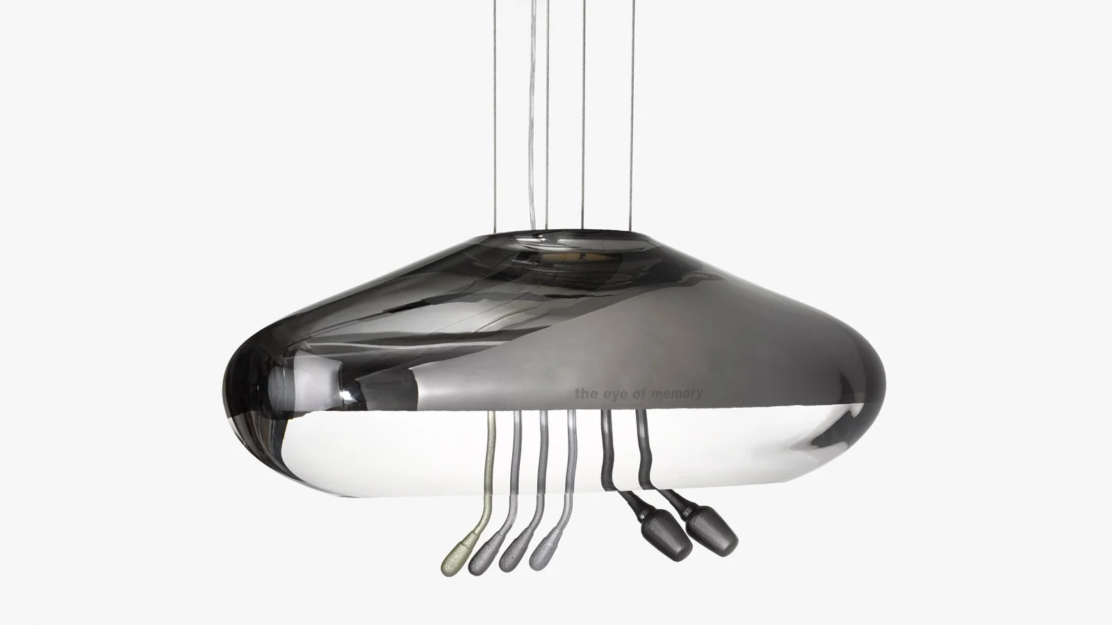 A modern, metallic, reflective pendant light fixture with five hanging cords and two black attached devices, set against a plain light background.