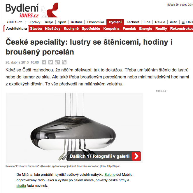 Shiny, silver pendant lamp with multiple thin, black cords hanging from the ceiling.