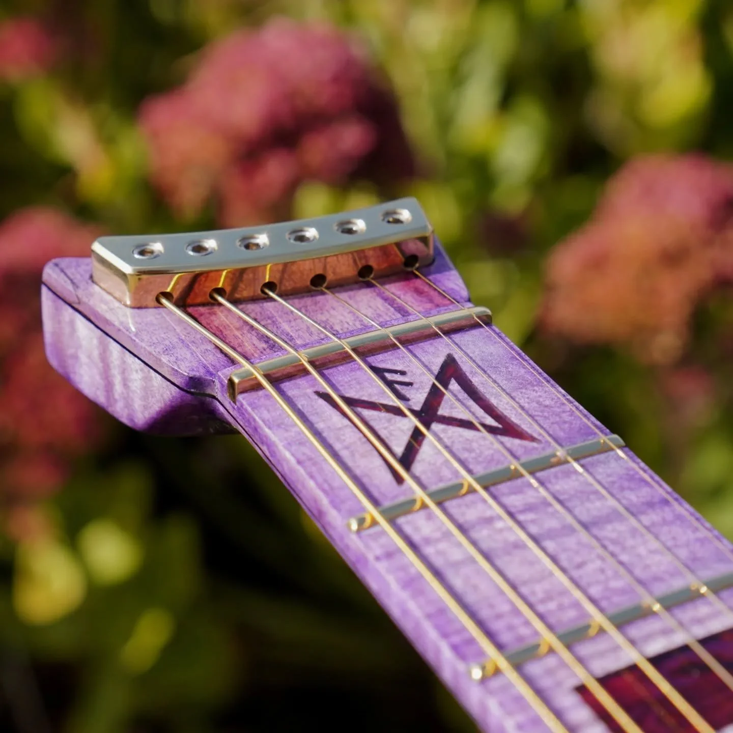 Not only is this the first Dreamweaver guitar, it is also the first one to feature my new custom headpiece string lock. This one is machined in house from brass and then polished to a mirror finish. For a clean look and strong connection it attaches 