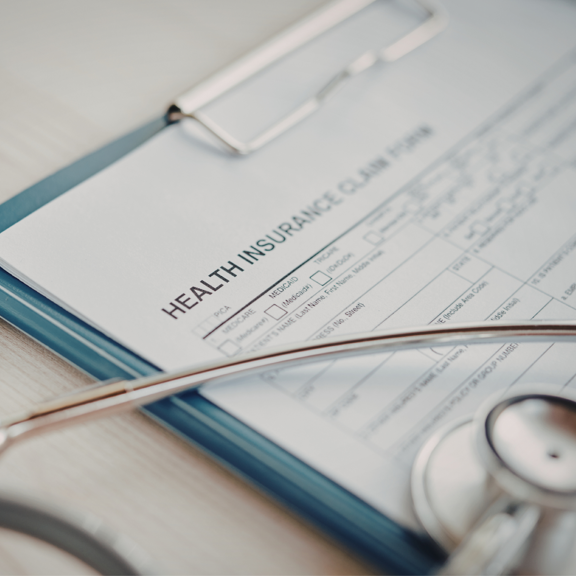 A man with dreadlocks, wearing a face mask, holding a naked baby with a surprised expression in his arm.