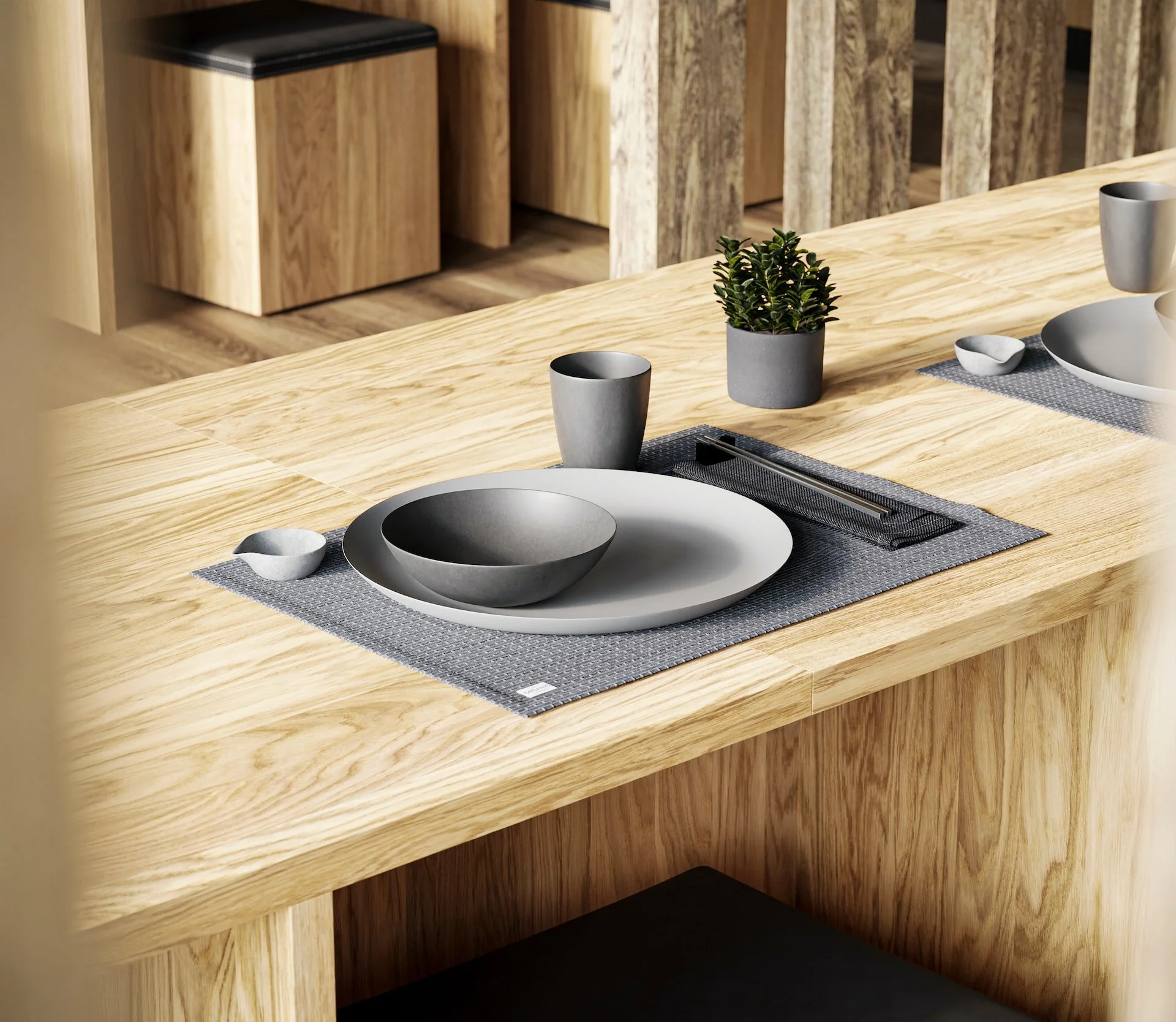 Premium Squarespace Template, Interior Design Squarespace Template, Avelã Creative. Minimalist dining table setup with gray plates, bowls, cup, chopsticks, and small plant on a wooden table.