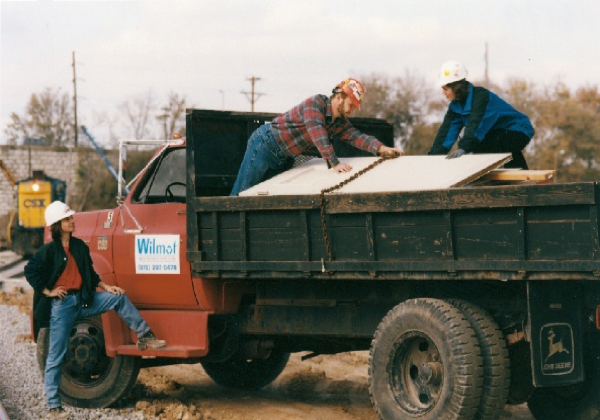 Workers loading materials onto a truck at a construction site