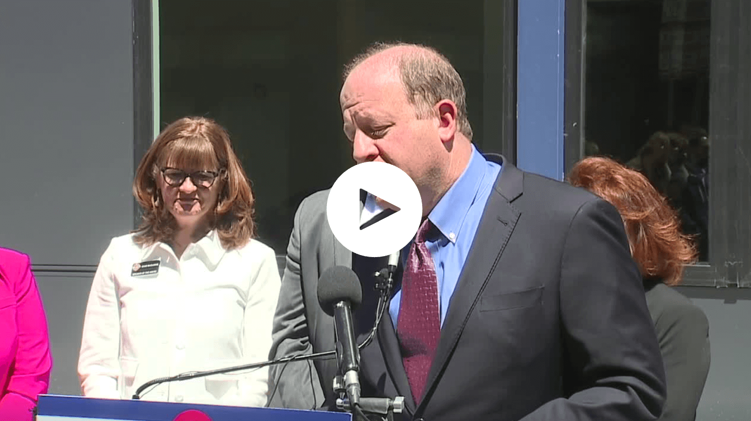 Governor Polis speaks at a microphone