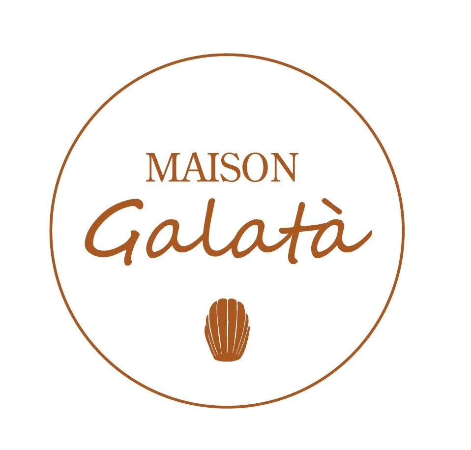 Logo for Maison Galatà with a round design, brown text, and a small cocoa bean icon at the bottom.