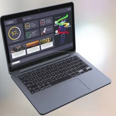 Silver laptop on a light-colored surface displaying a dashboard with charts, icons, and images.