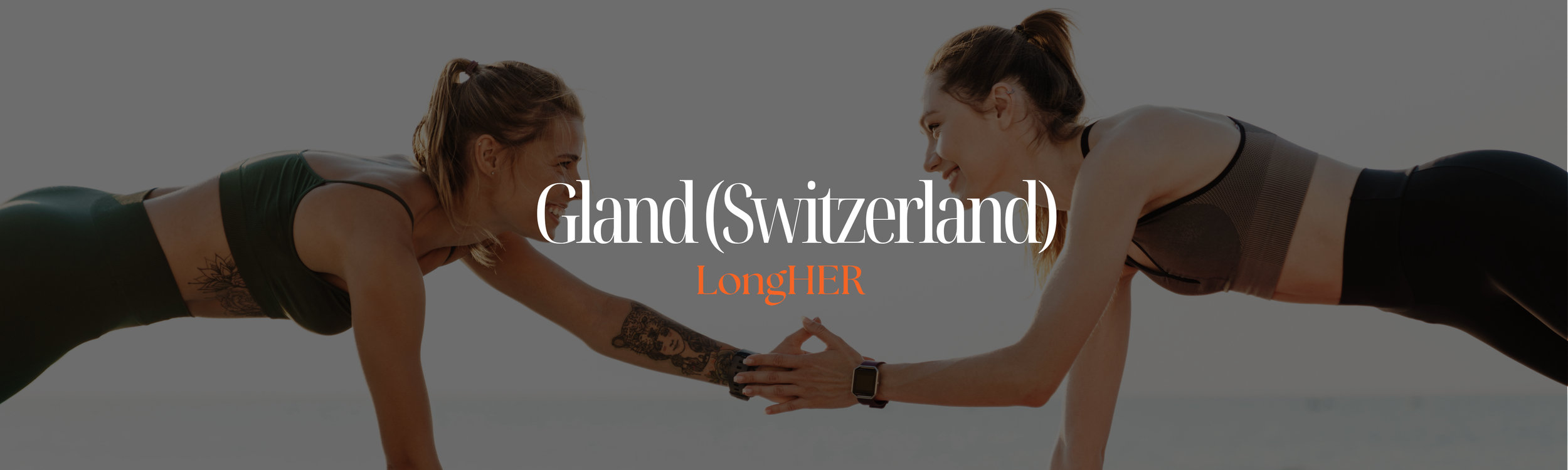 A boat sailing on a body of water with a fountain spraying water high into the sky and a small lighthouse in the background, under a partly cloudy sky.