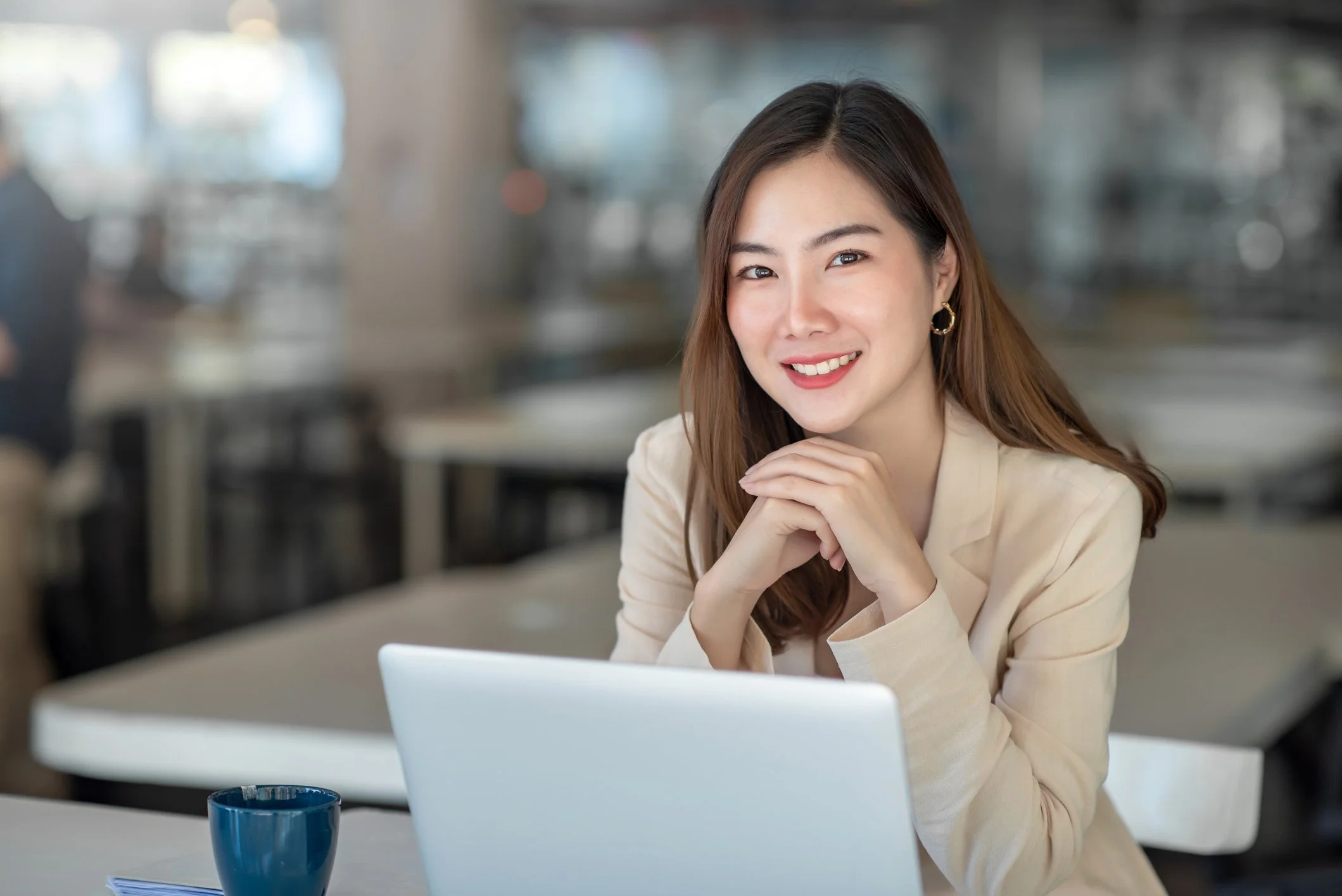 Asian woman sitting in front of laptop