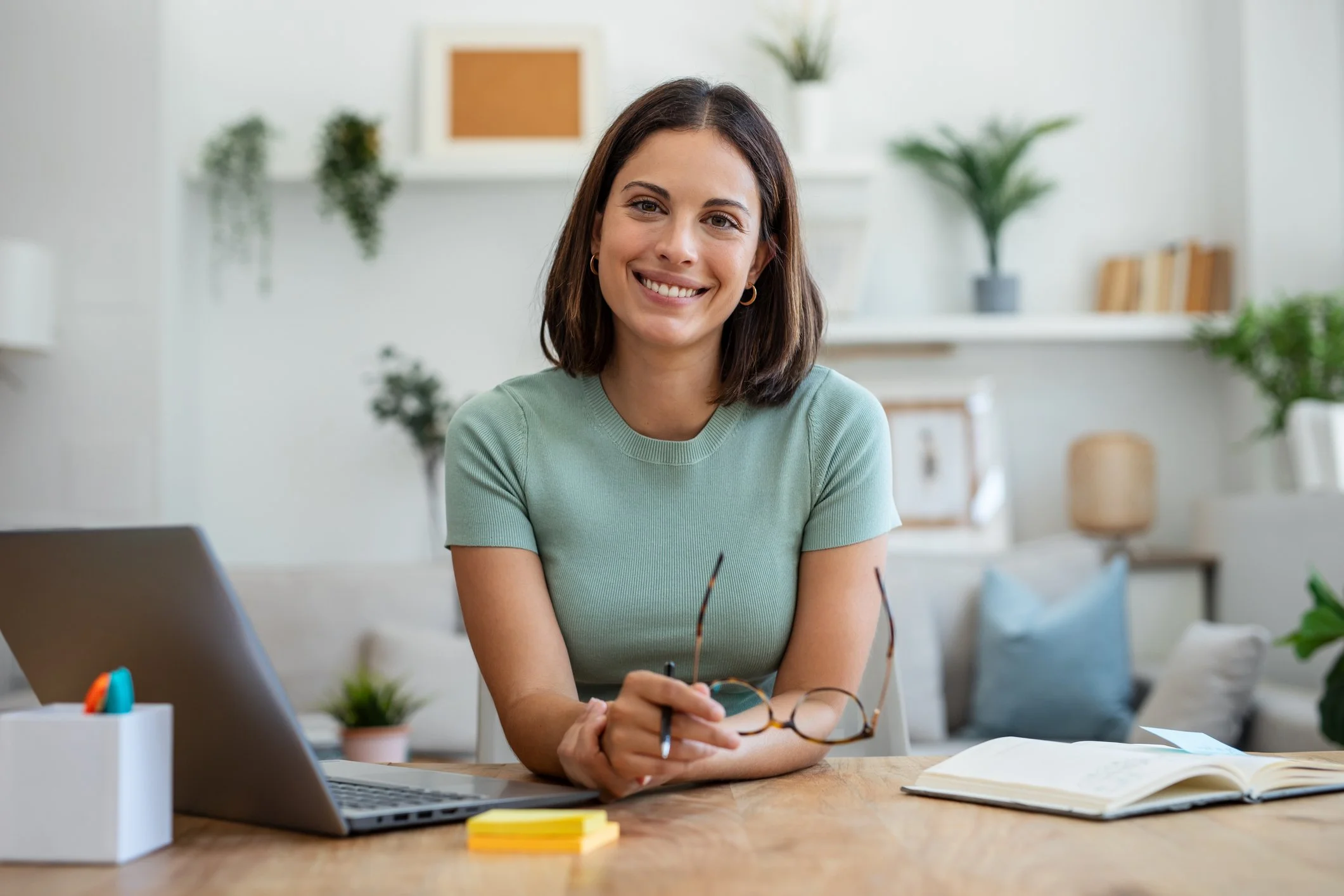 young professional woman holding glasses smiling