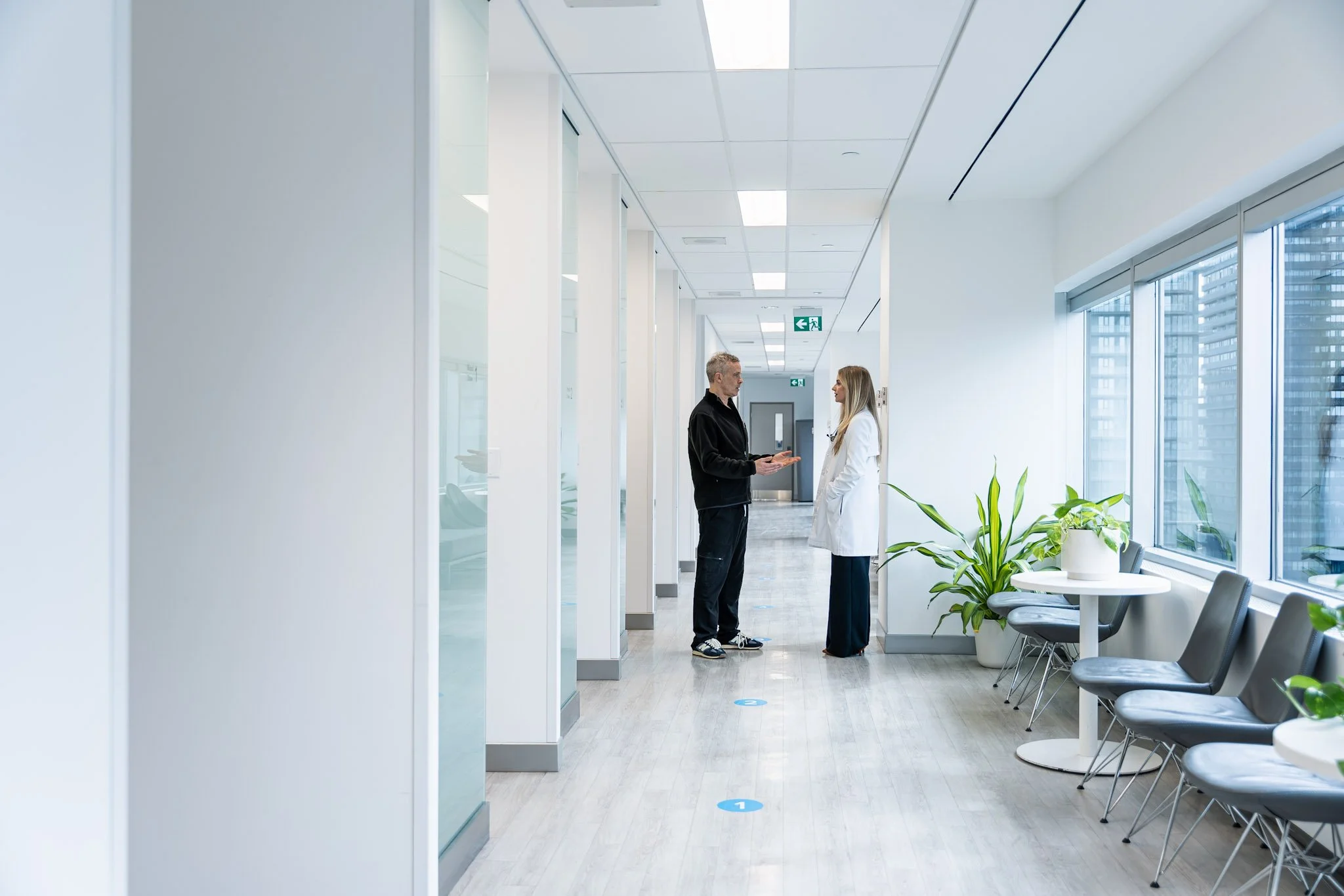 Dr. Tom Hannam speaking with Dr. Taryn Yermus in the hallway at Hannam Fertility Centre