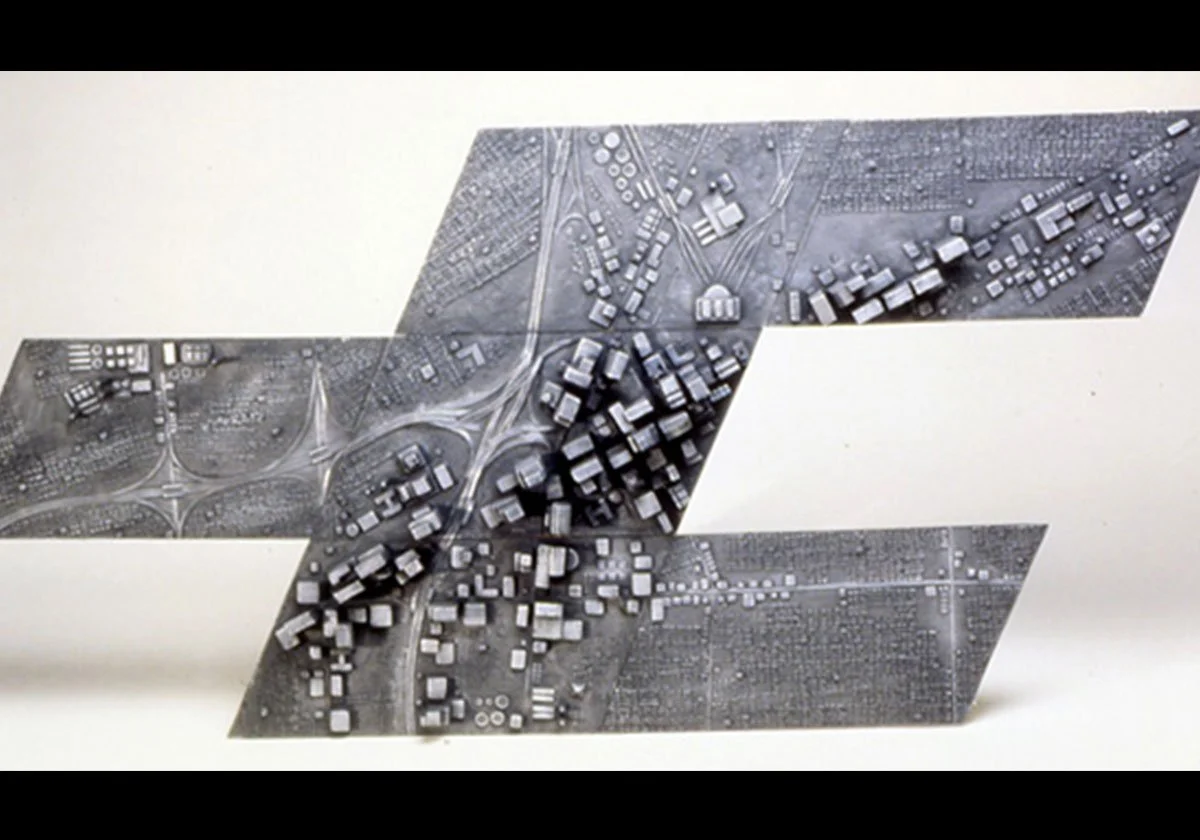 Black and white model of a city with roads, intersections, and buildings arranged in overlapping layers.