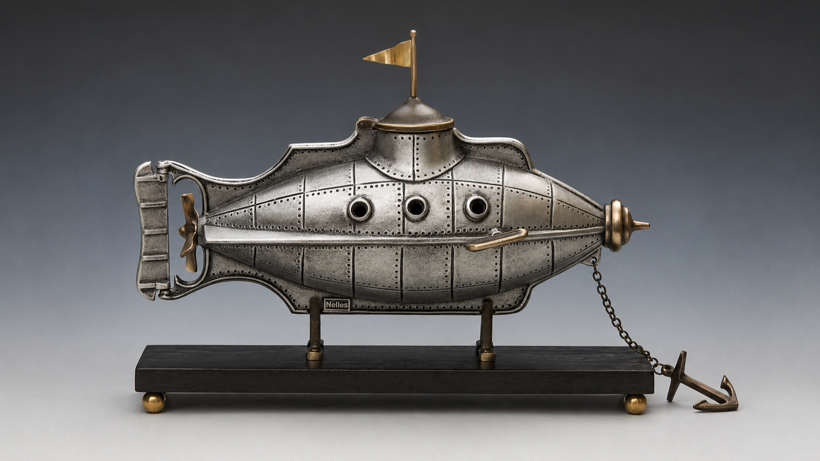 A steam punk inspired bronze and aluminum submarine on a black wooden base and a chain with an anchor.