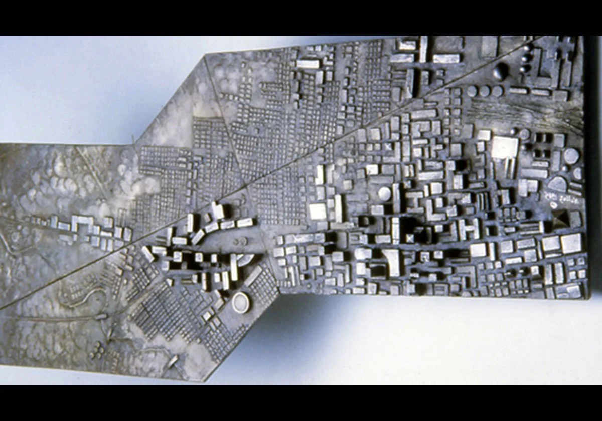 A detailed model of a city with various buildings, roads, and terrain features.