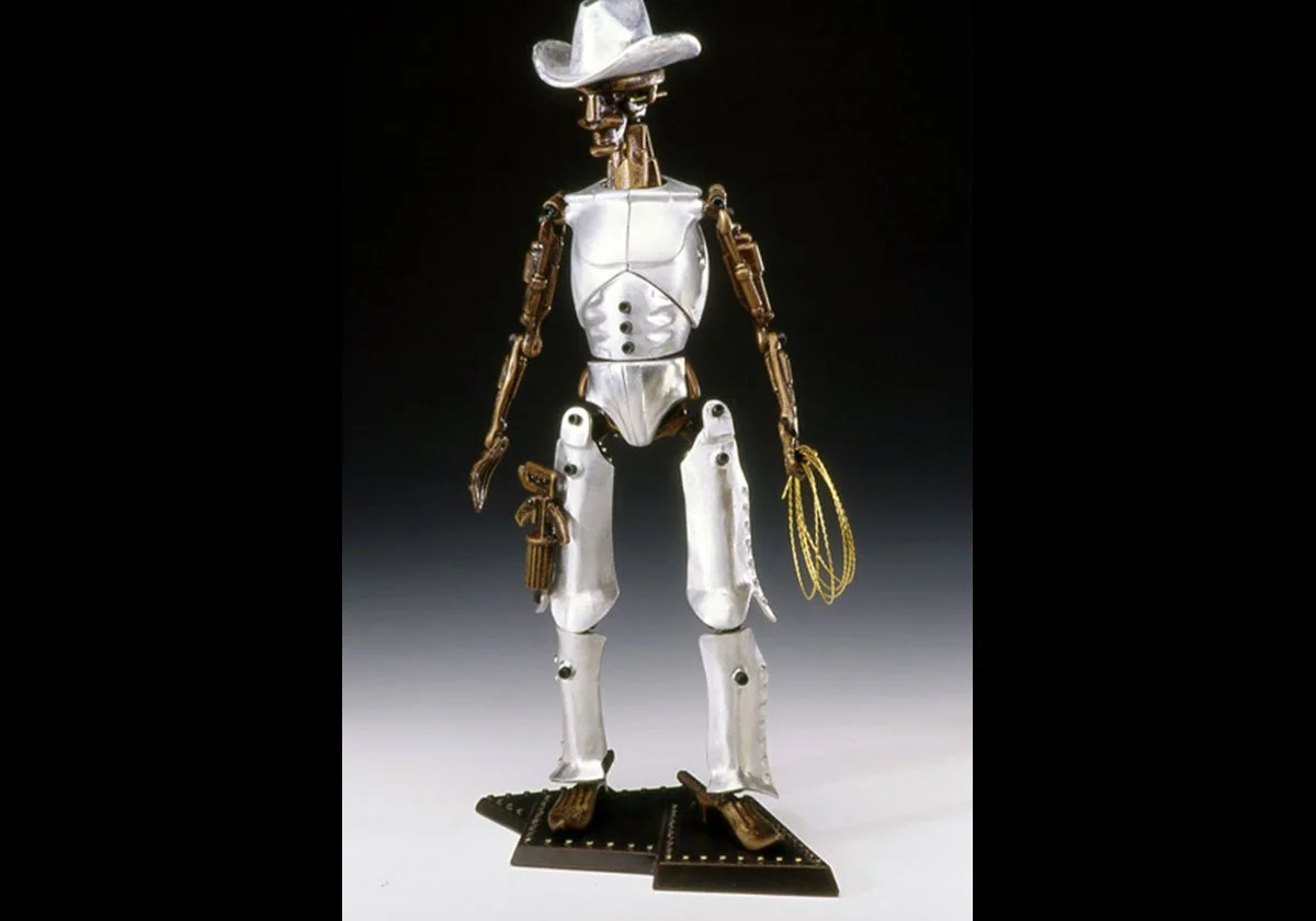 A robot with a cowboy hat, metal limbs, and a metallic body, standing on a black platform, holding a lasso in one hand and a pistol in another, with a dark background.