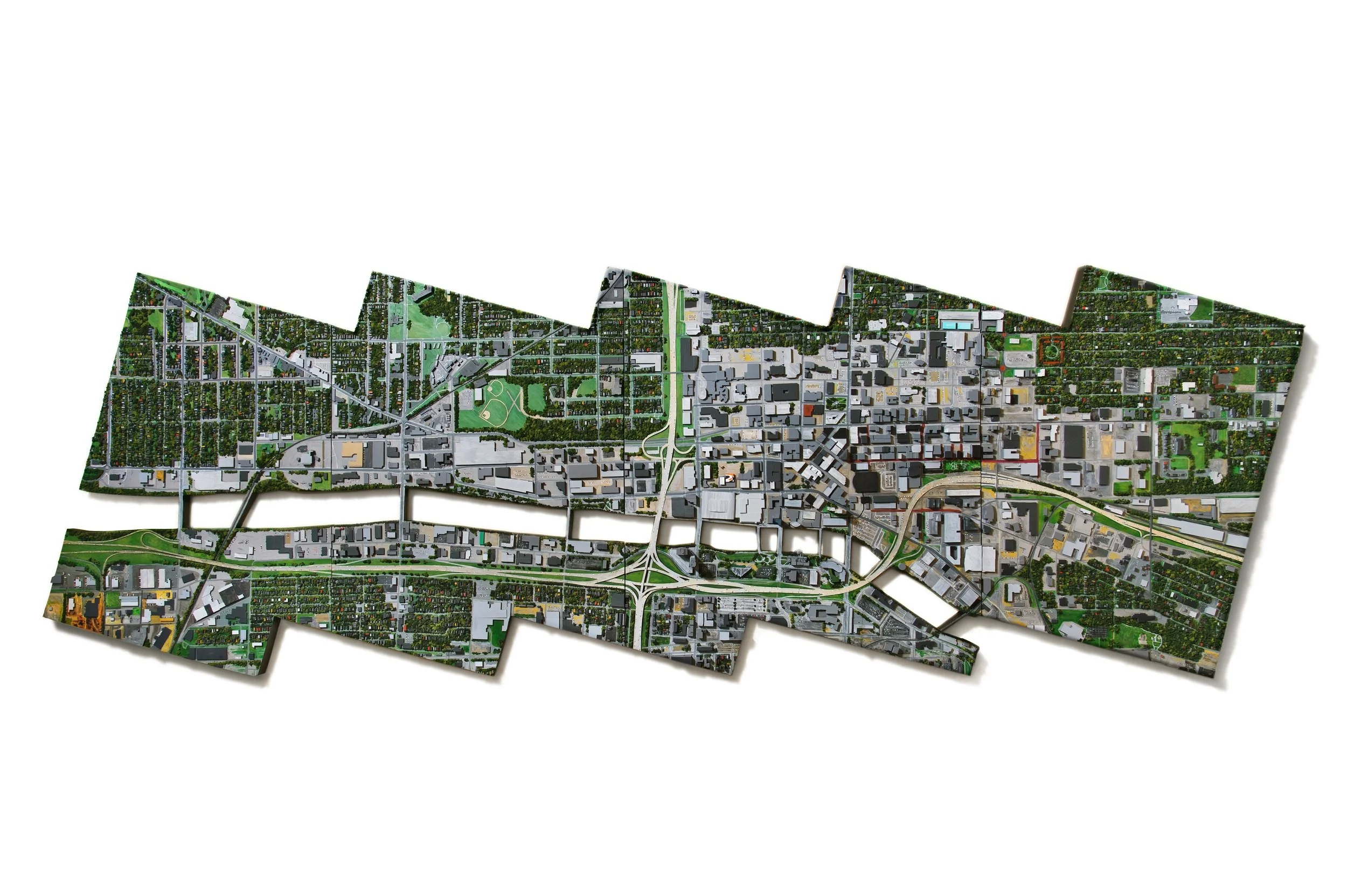 An aerial map from ArtPrize 2024 Grand Rapids. Showcasing an urban area with streets, parks, and buildings, presented in a collage style with cut-out sections.