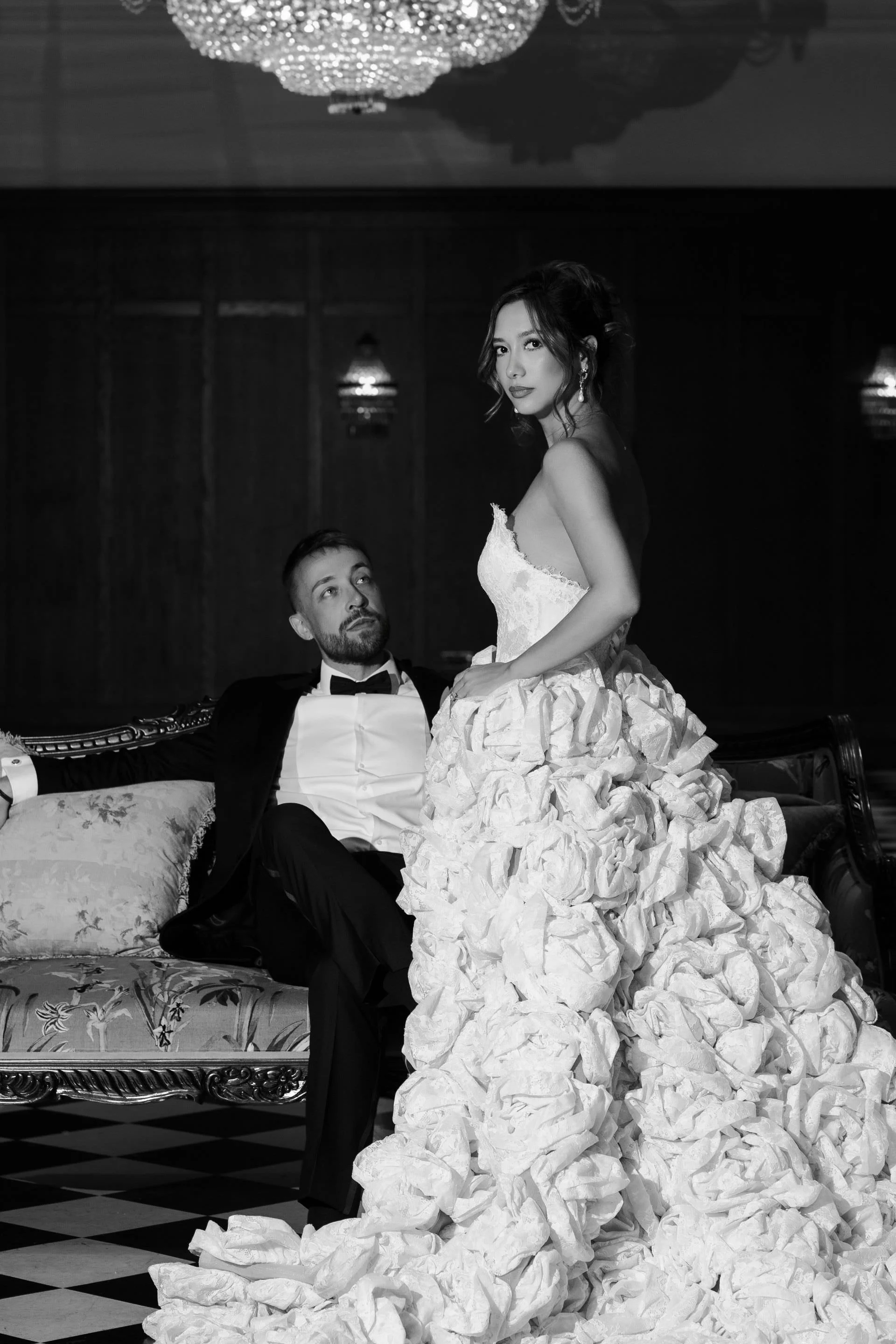 Black and white editorial wedding portrait of a bride and groom in an elegant London venue.