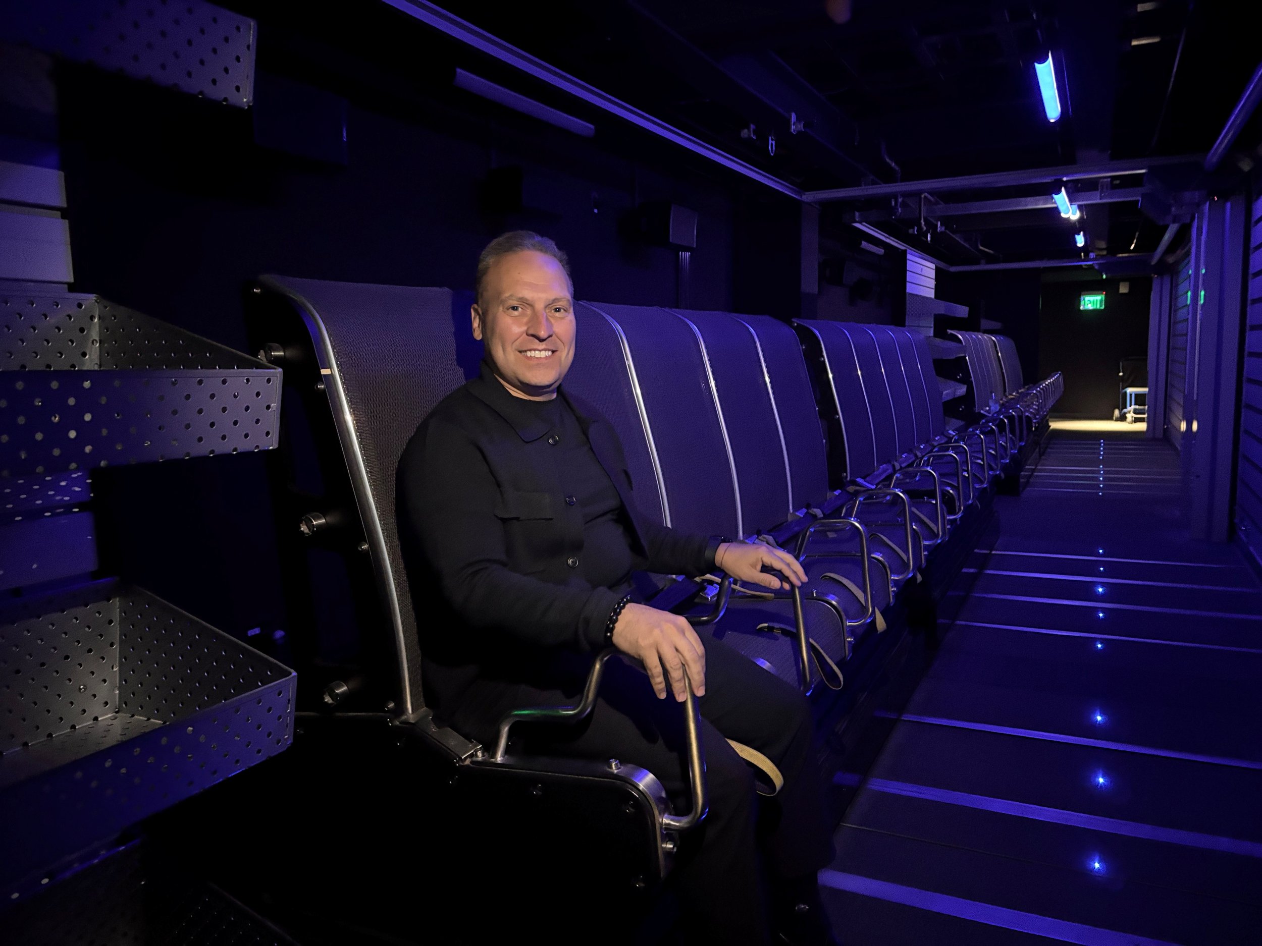 Sal Agosta, Senior Vice President of Architecture & Design, sitting in a FlyRide flying theater seat.