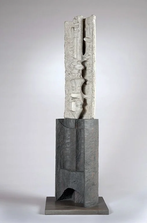 Abstract sculpture by Angelo Granata with textured white and gray vertical forms on a rectangular base