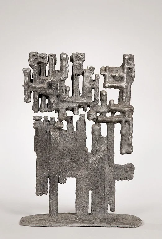 Abstract metal sculpture titled HETEROS by Angelo Granata with geometric forms on a flat base