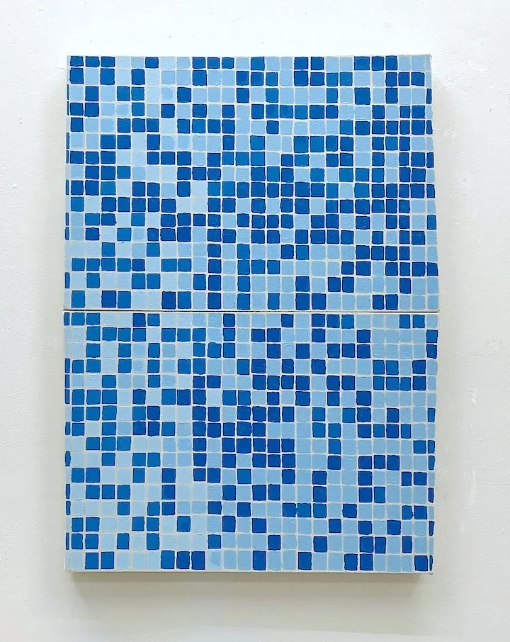 Blue mosaic pattern on a rectangular canvas hanging on a white wall.
