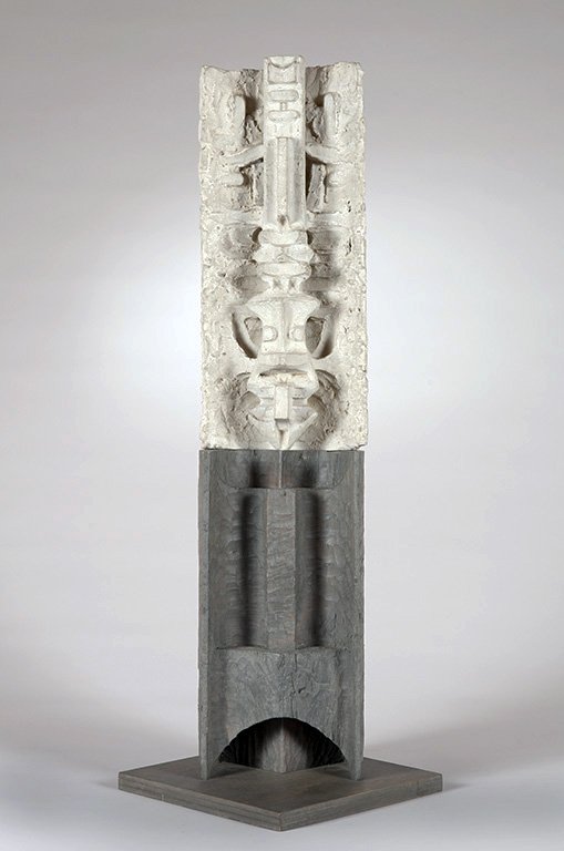 Abstract vertical sculpture by Angelo Granata composed of a textured, light-colored upper section and a smooth, dark gray lower section, standing on a square base against a plain background.