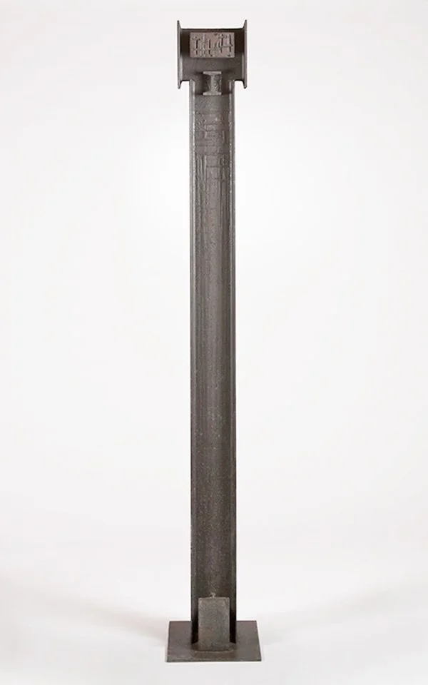 Tall vertical industrial steel sculpture by Angelo Granata with a square base against a plain background.