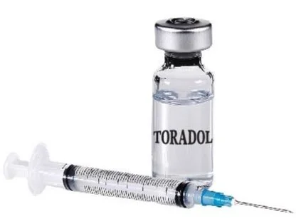 A vial labeled 'Toradol' and a syringe filled with a clear liquid.