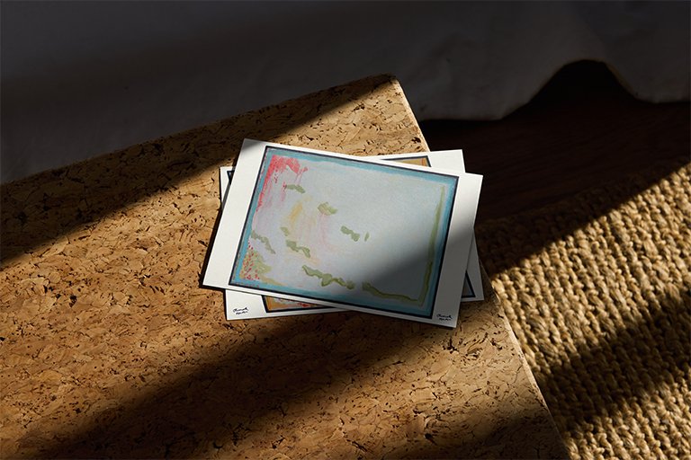 "This Must Be the Place (4)" print amongst a pile of postcards.