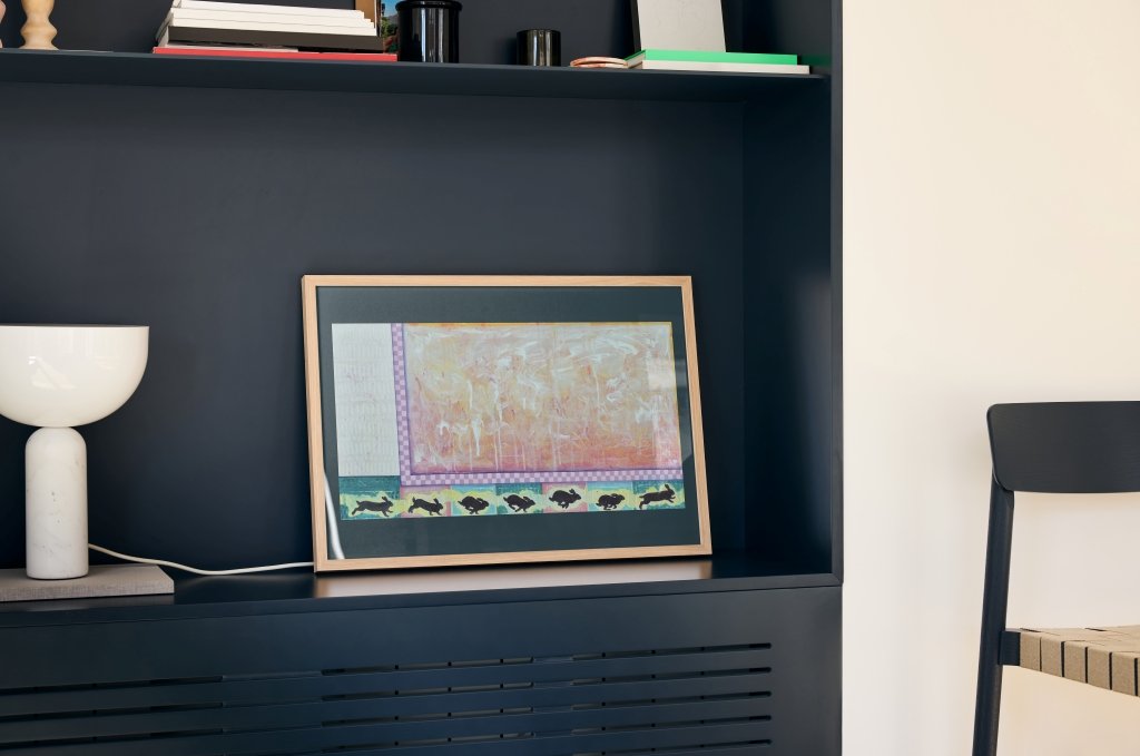 "The Chase" print displayed in a modern office environment.