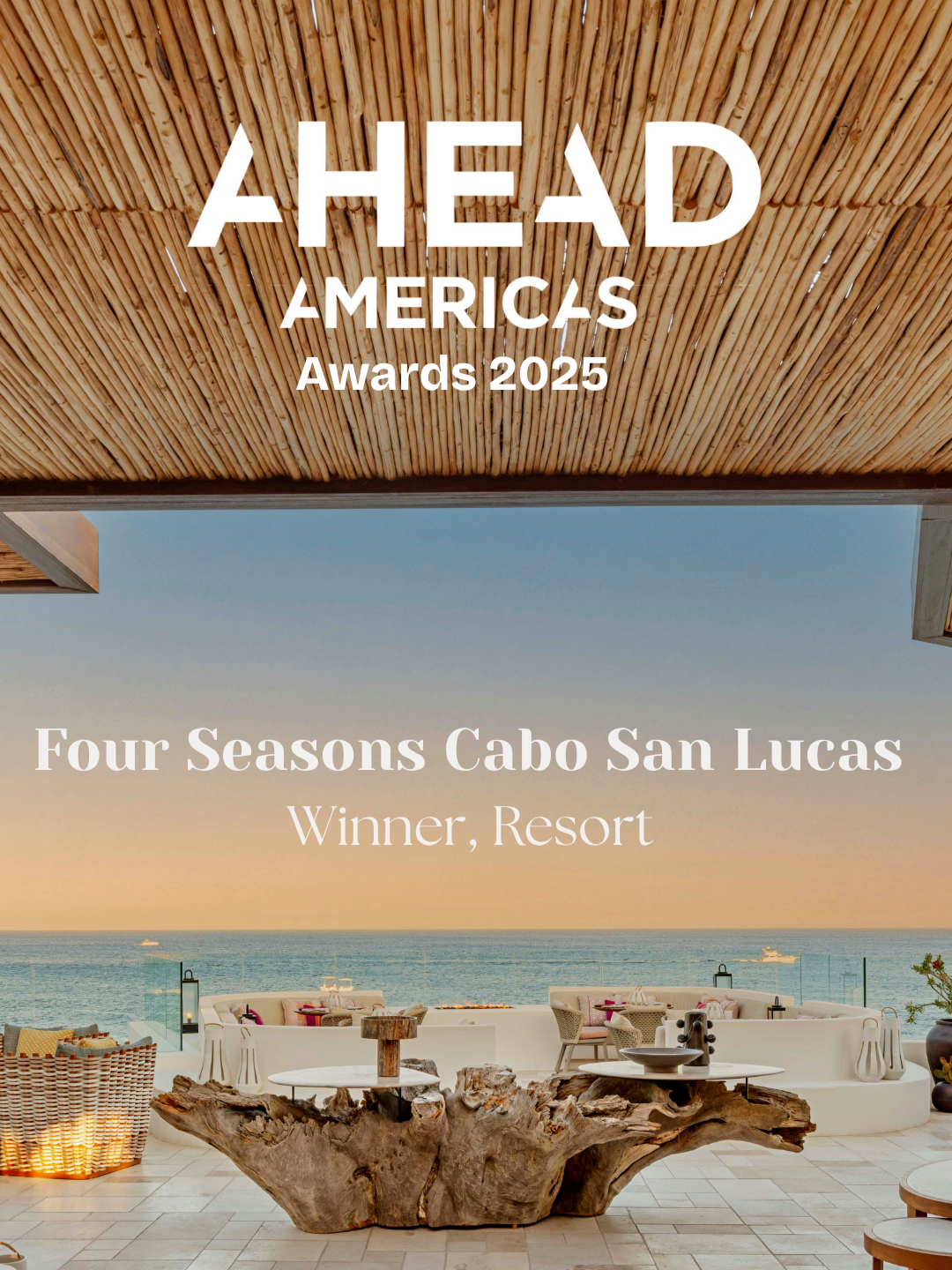 An outdoor resort scene with a wooden ceiling, ocean view, and seating area featuring a large piece of driftwood as a table at Four Seasons Cabo San Lucas, winner of the 2025 AHEAD Americas Awards.
