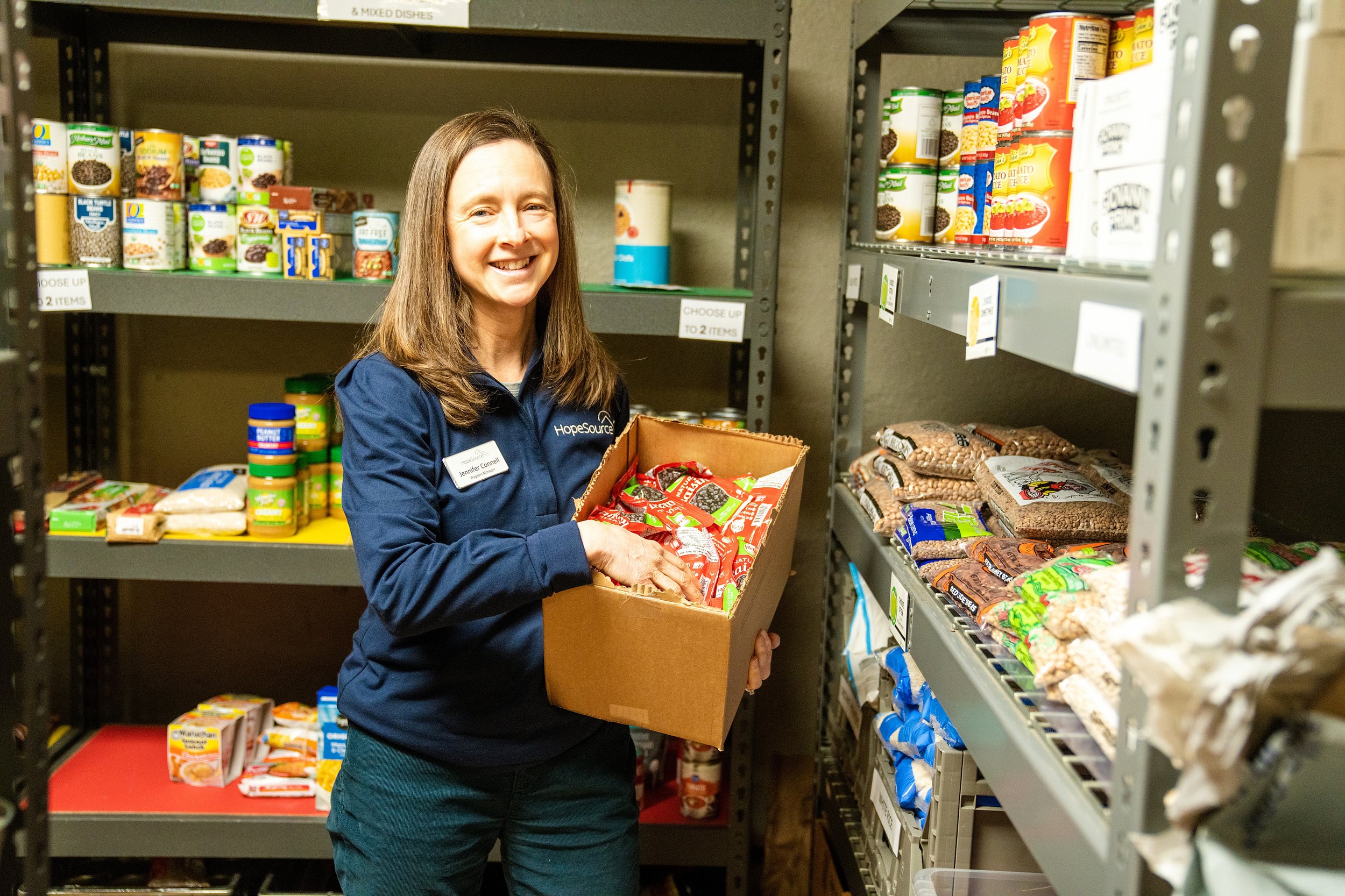 Woman Stocking Shelves at Food Bank