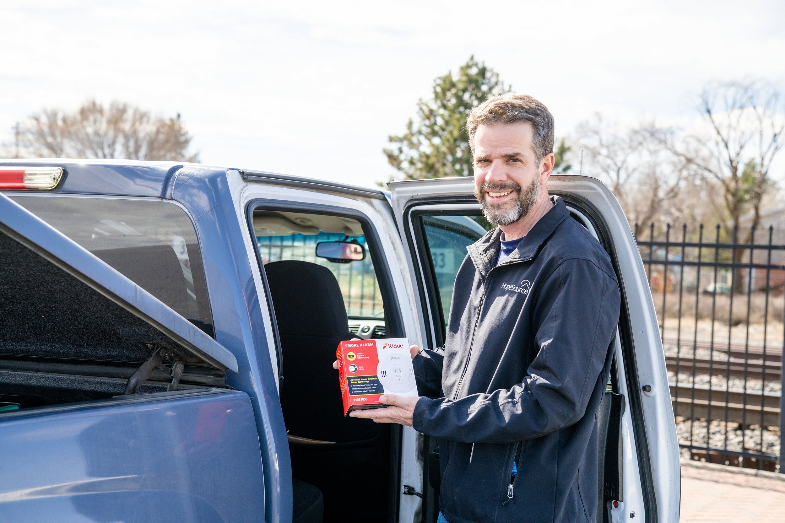 man holding smoke detector