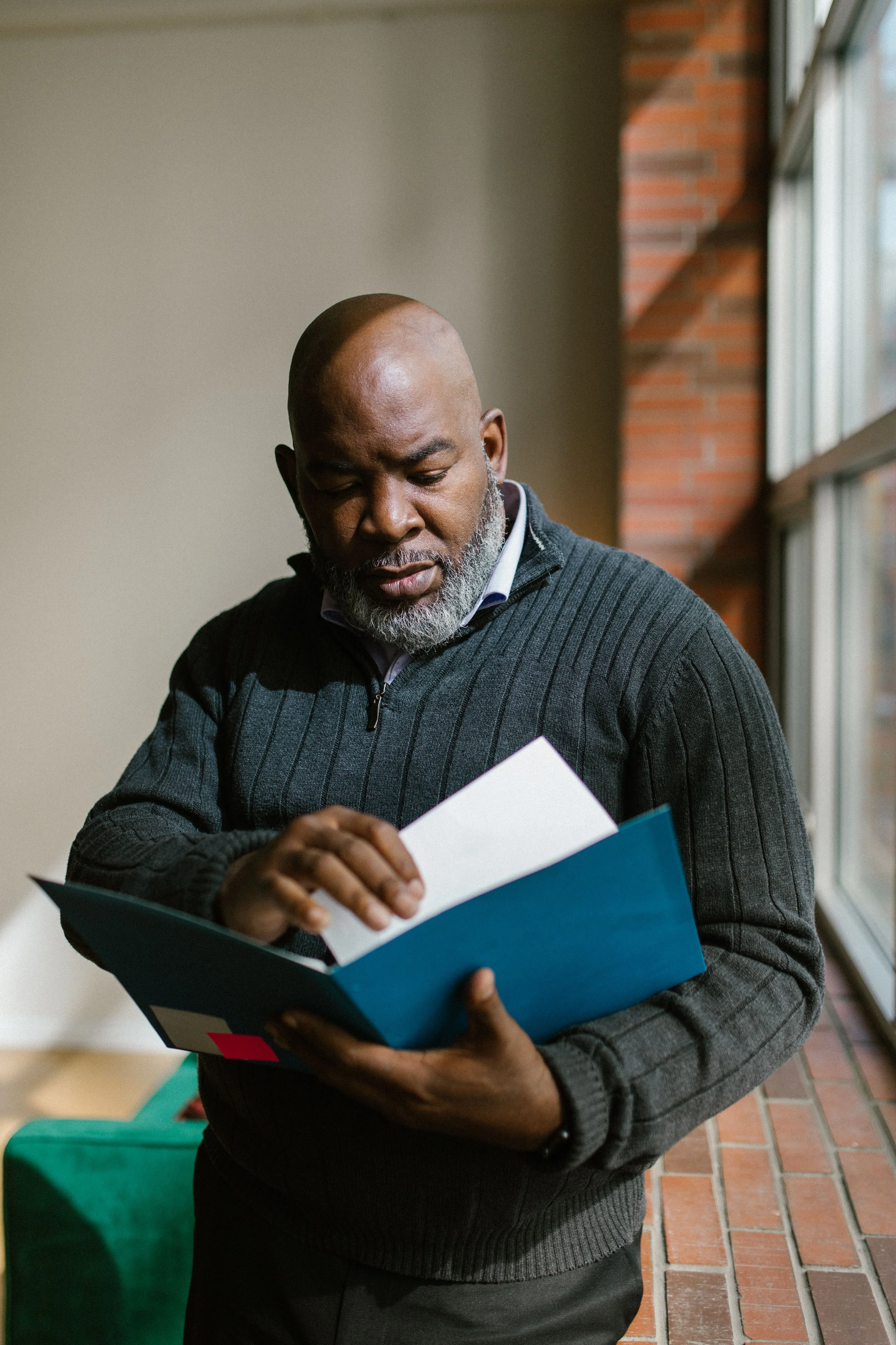 Volunteer church treasurer reviewing financial documents and organized records.