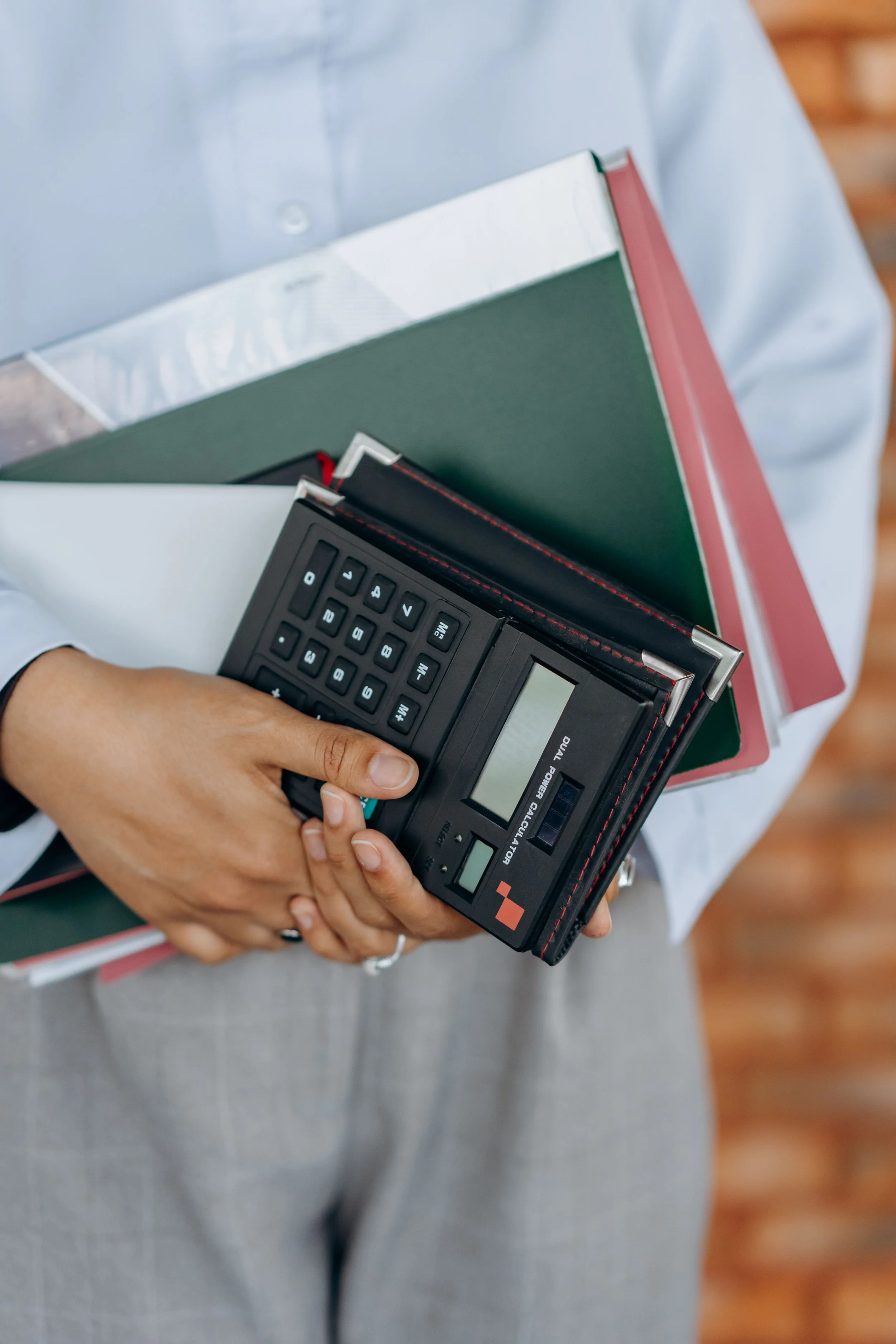 Church bookkeeping records, folders, and a calculator organized for a clear and complete financial handoff.