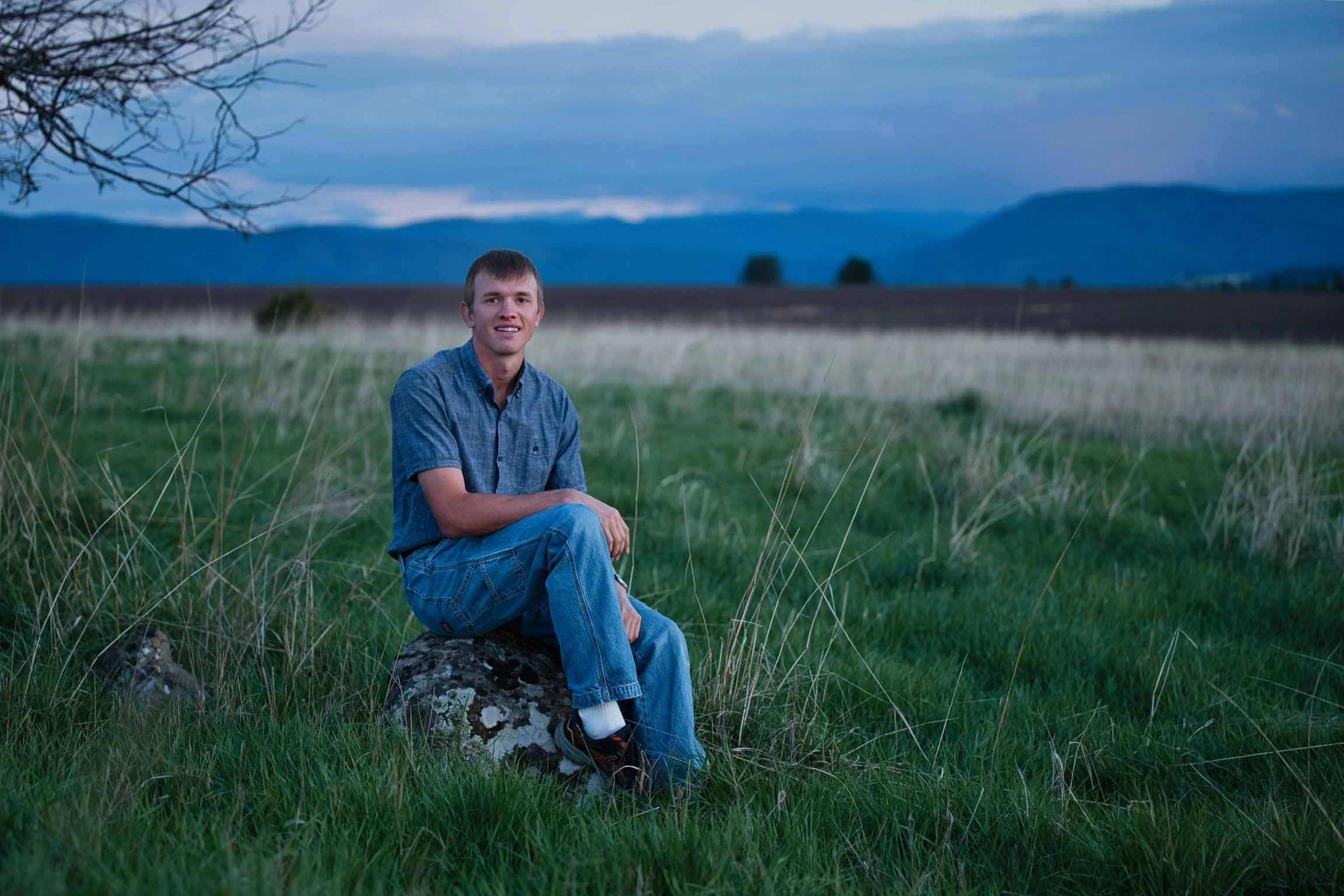 Black and white photo of a person sitting in the driver's seat of a vintage Ford F250 Ranger truck.