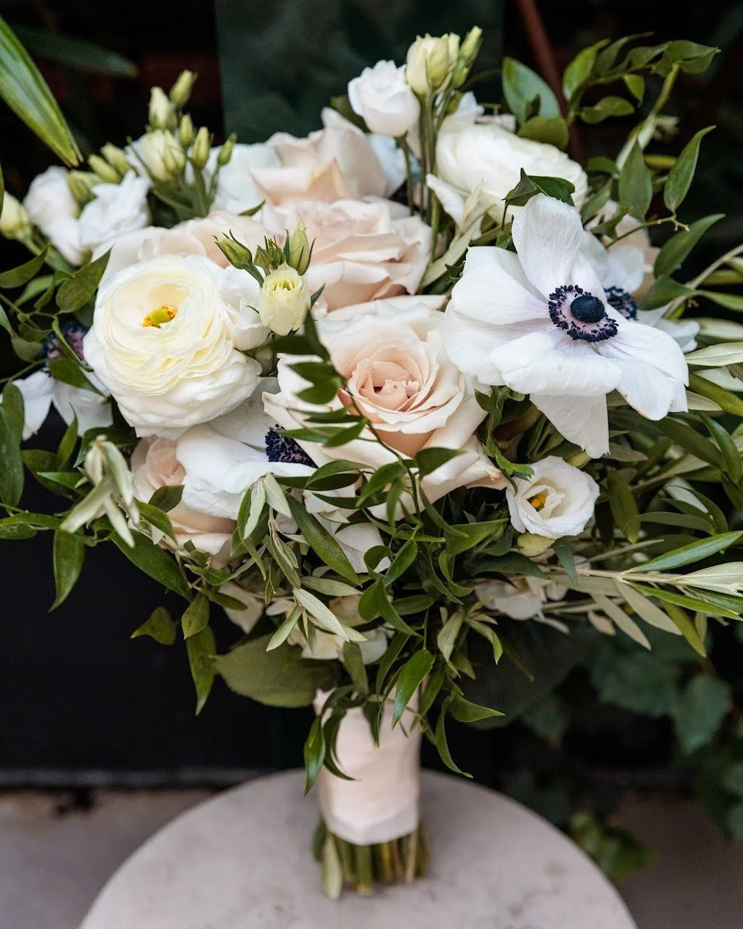 A thoughtfully composed bouquet is a centerpiece of bridal design. We love this blend of creamy whites, soft blushes, and rich greenery, which is both timeless and strikingly modern, thanks to the high-contrast elements. To ensure maximum quality and