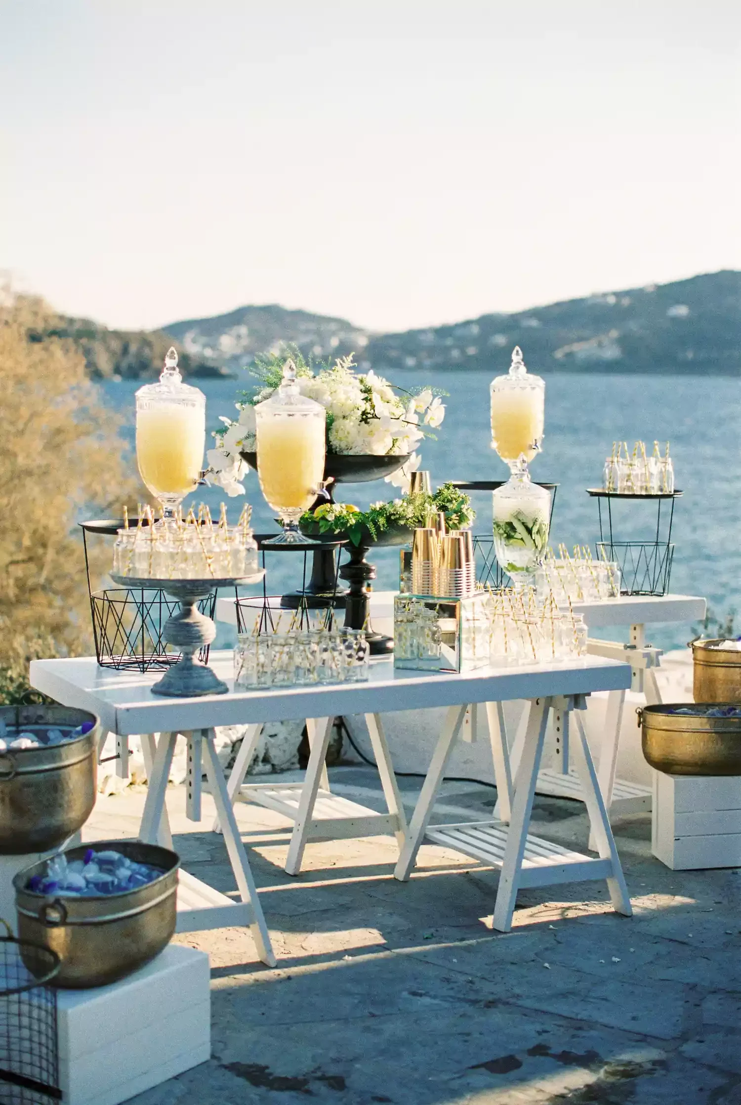 Luxury wedding guest experience featuring a modern hydration station and plush lounge seating.