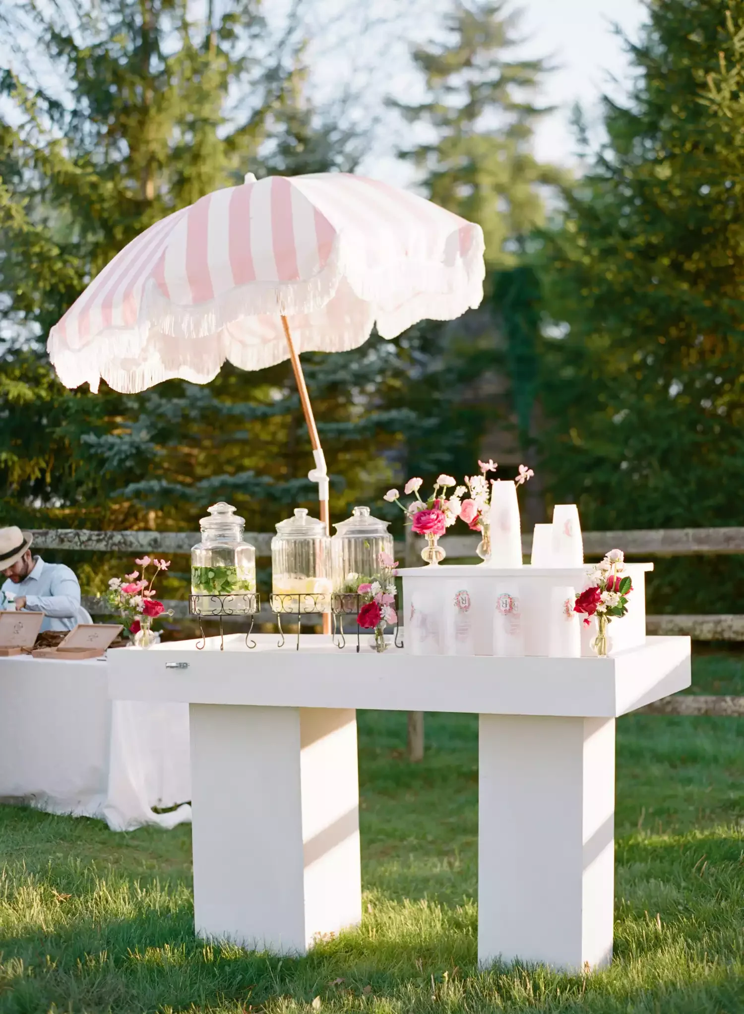 Luxury wedding guest experience featuring a modern hydration station and plush lounge seating.