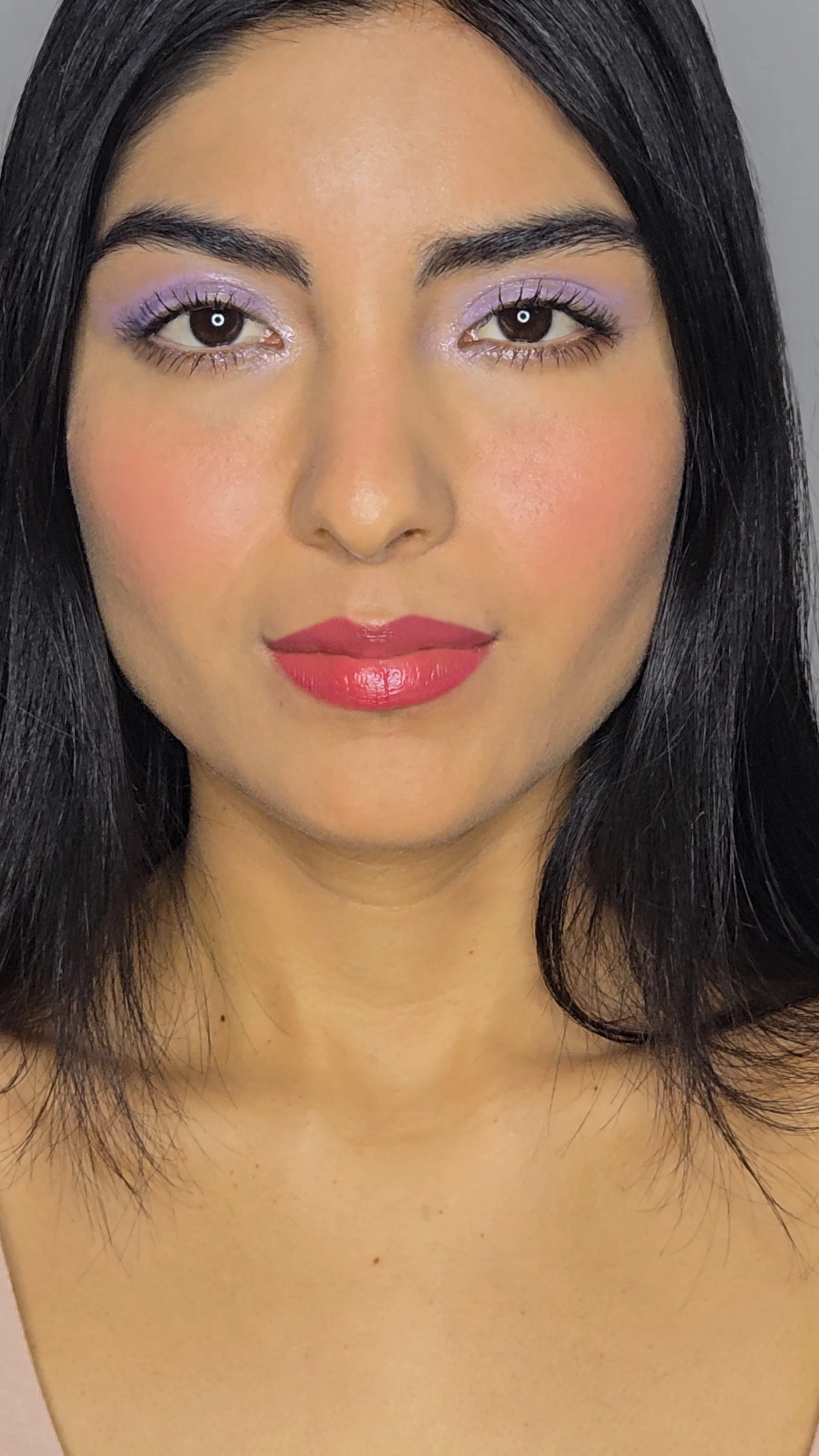 Behind-the-scenes portrait of a model with copper and silver glitter eye makeup and natural pink lip. Link to professional makeup videos and commercial beauty reels by Robin Schoen.