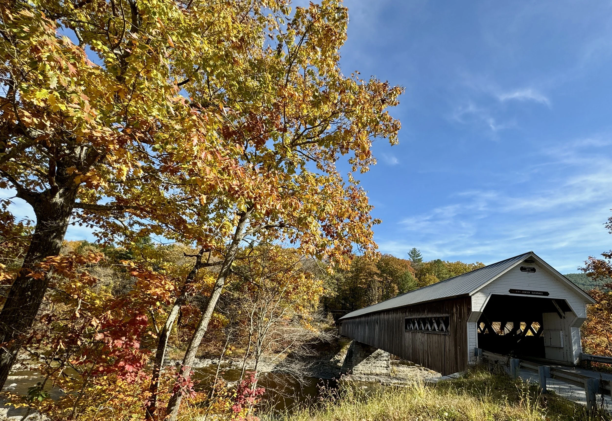 Covered bridge surrounded by Vermont fall foliage