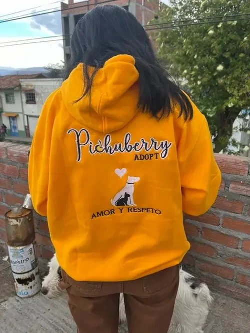 Woman in a yellow Pichuberry hoodie