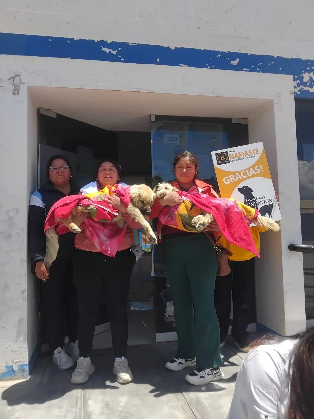 women holding rescue dogs