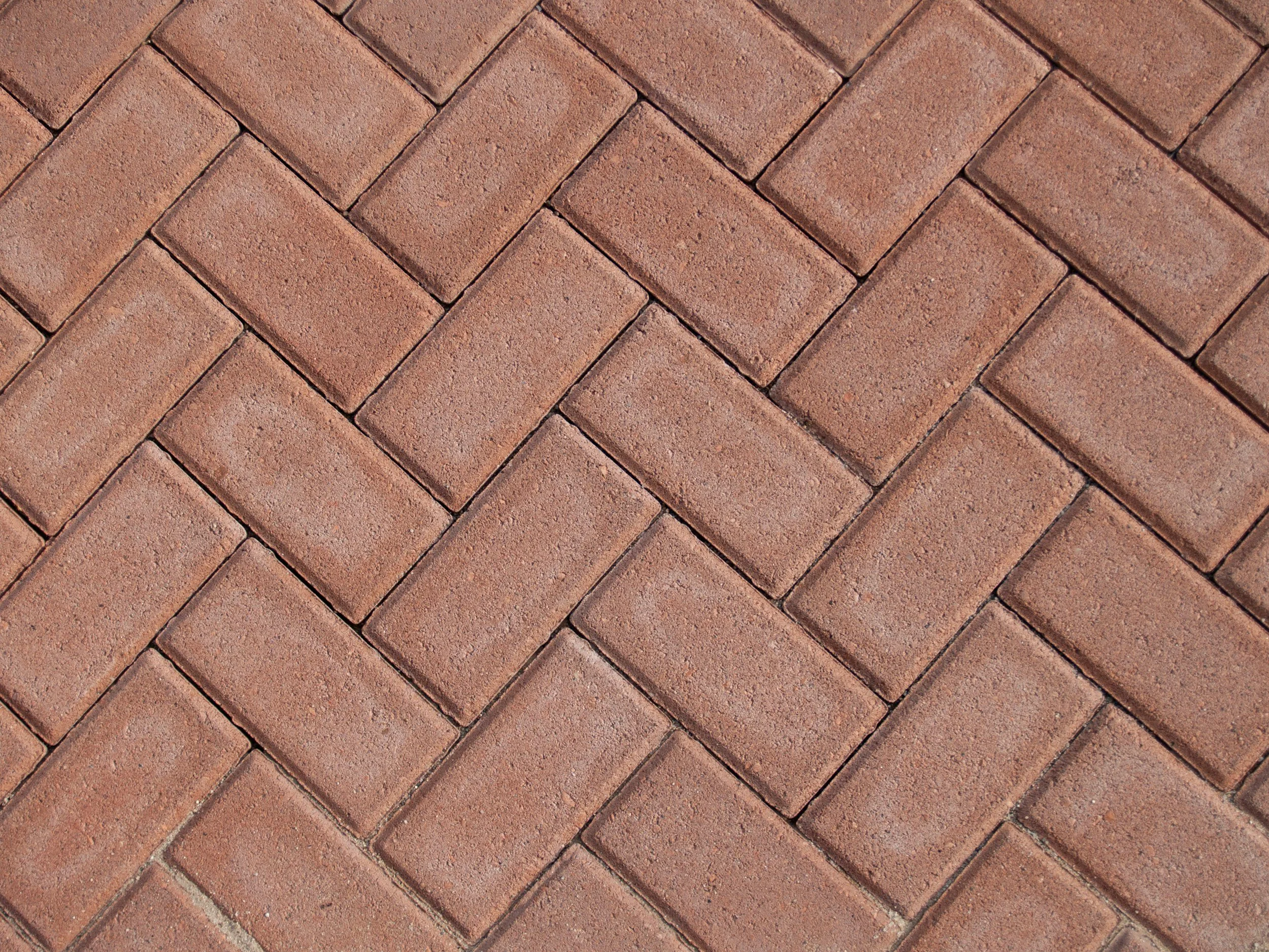 Herringbone brick pattern on a paved surface