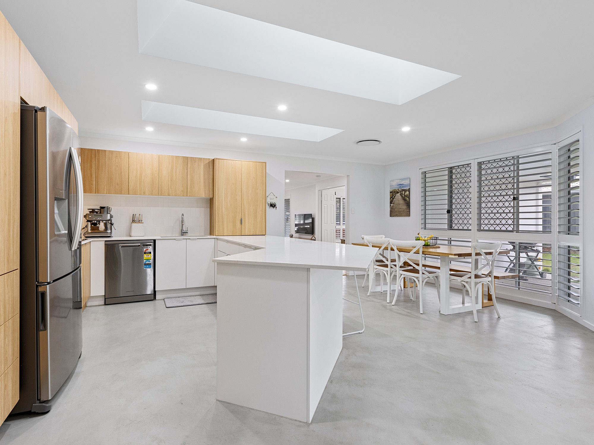 Skylights filling this kitchen / dining area with light