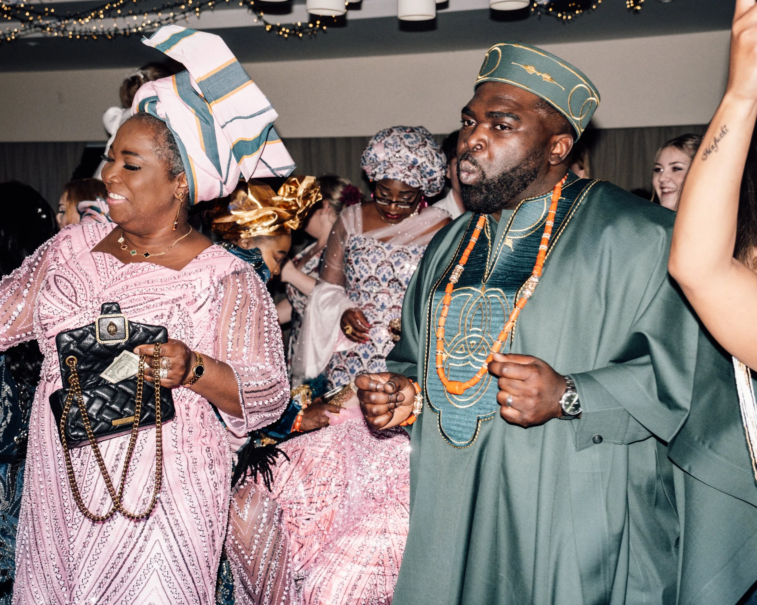 People dressed in traditional African attire, dancing and celebrating at cultural event or festival.