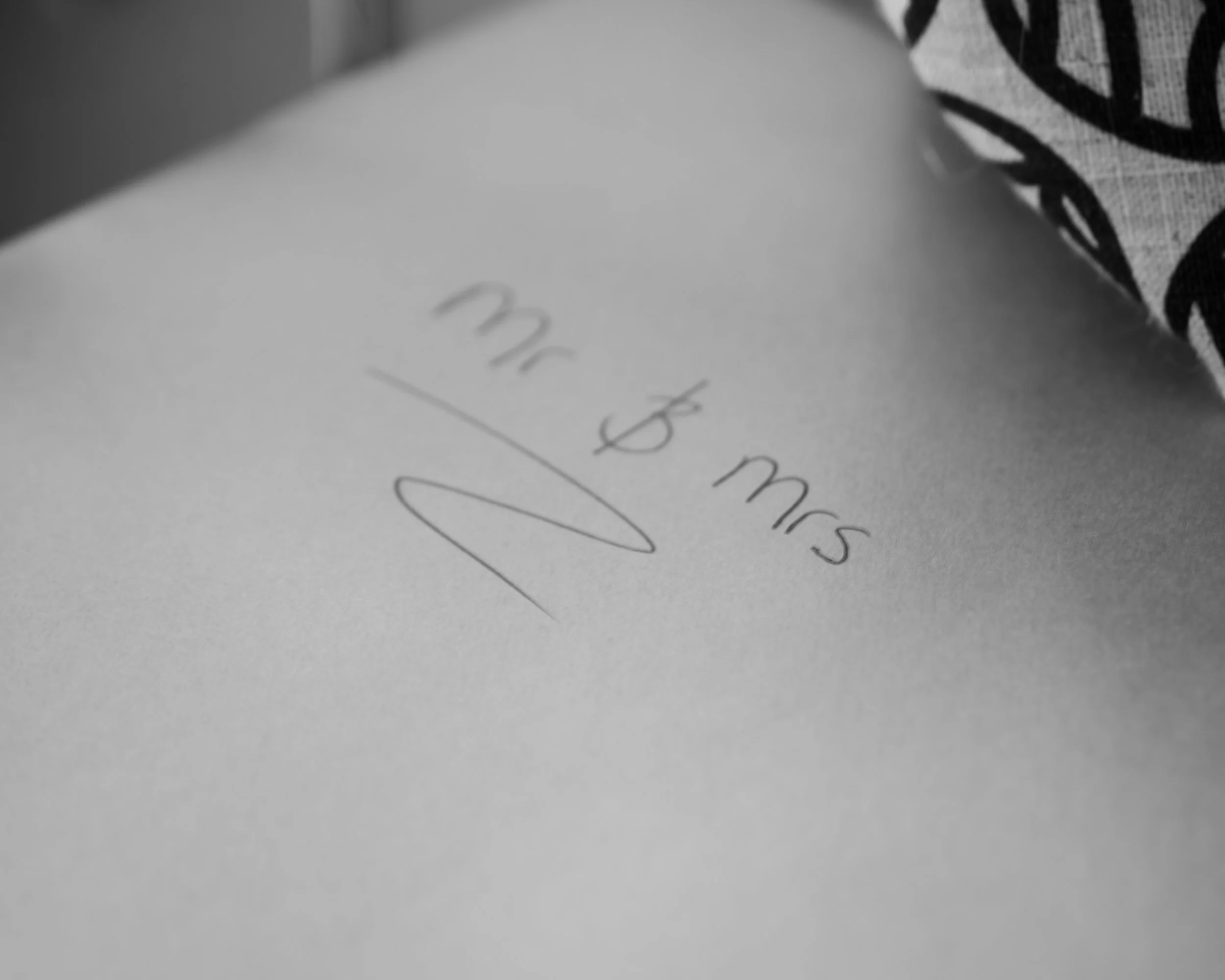 Close-up of a handwritten message on a white piece of paper, reading "I'm 3 months" with a signature underneath.